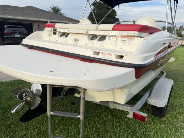 Bayliner 184 SF 2012 on trailer in yard.