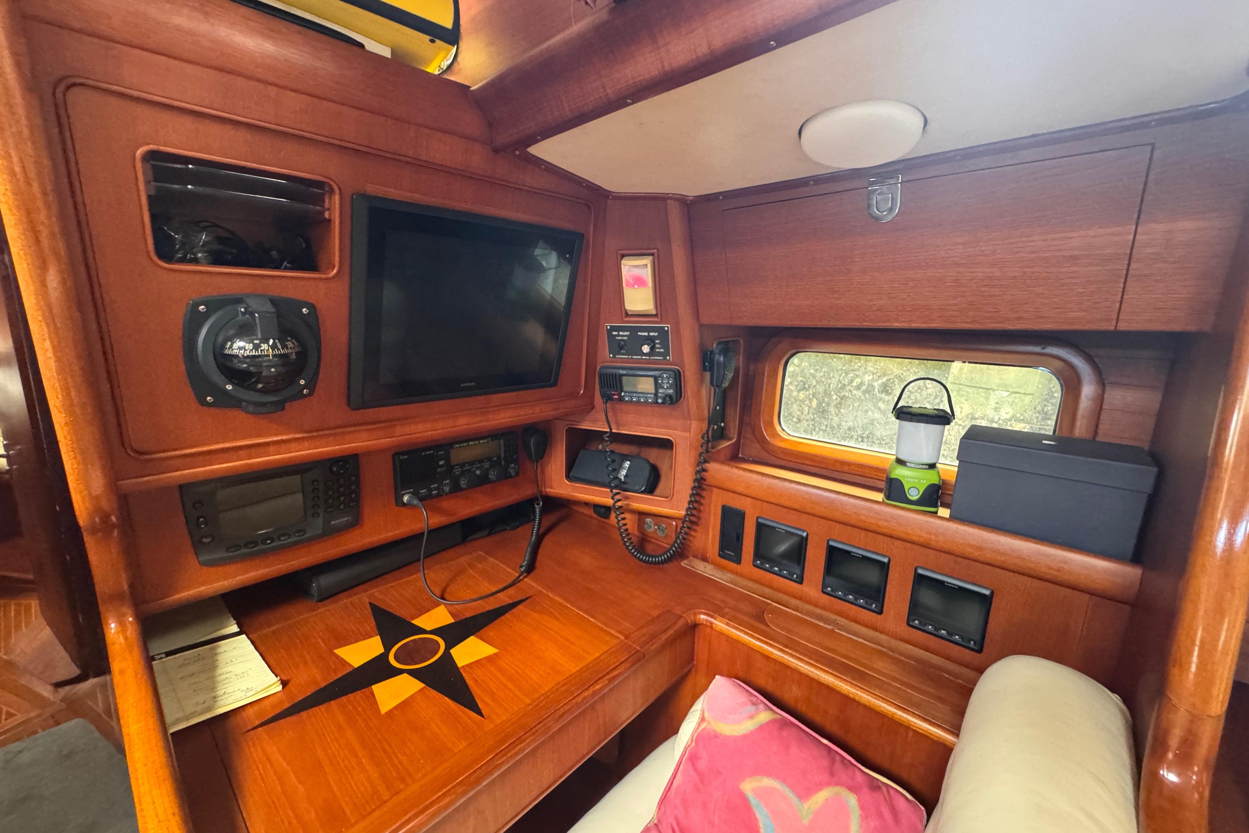 1989 Little Harbor Sloop 58' interior with navigation equipment and wooden finish.