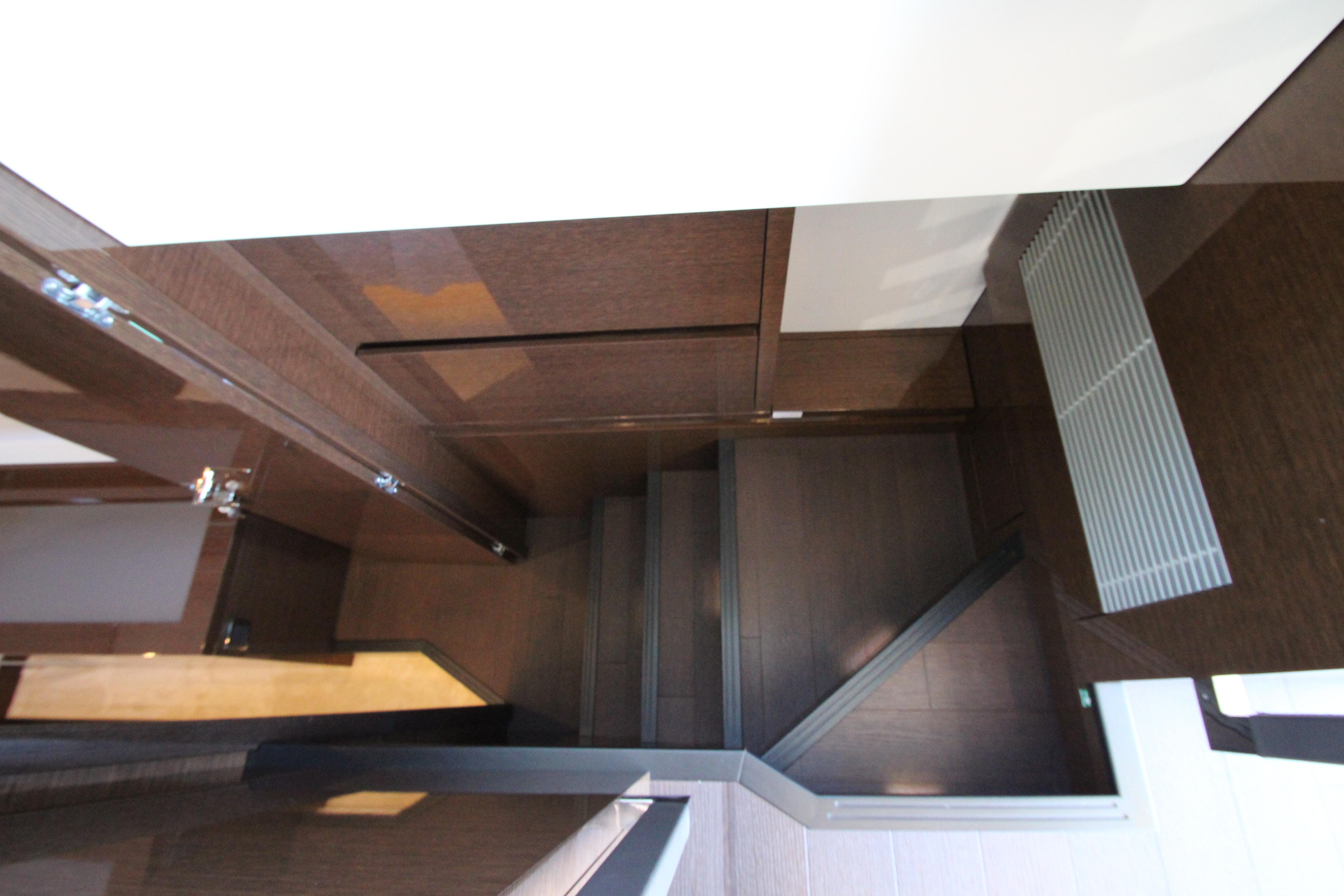 Modern interior staircase in 2022 Prestige 520 yacht, featuring sleek wooden design.
