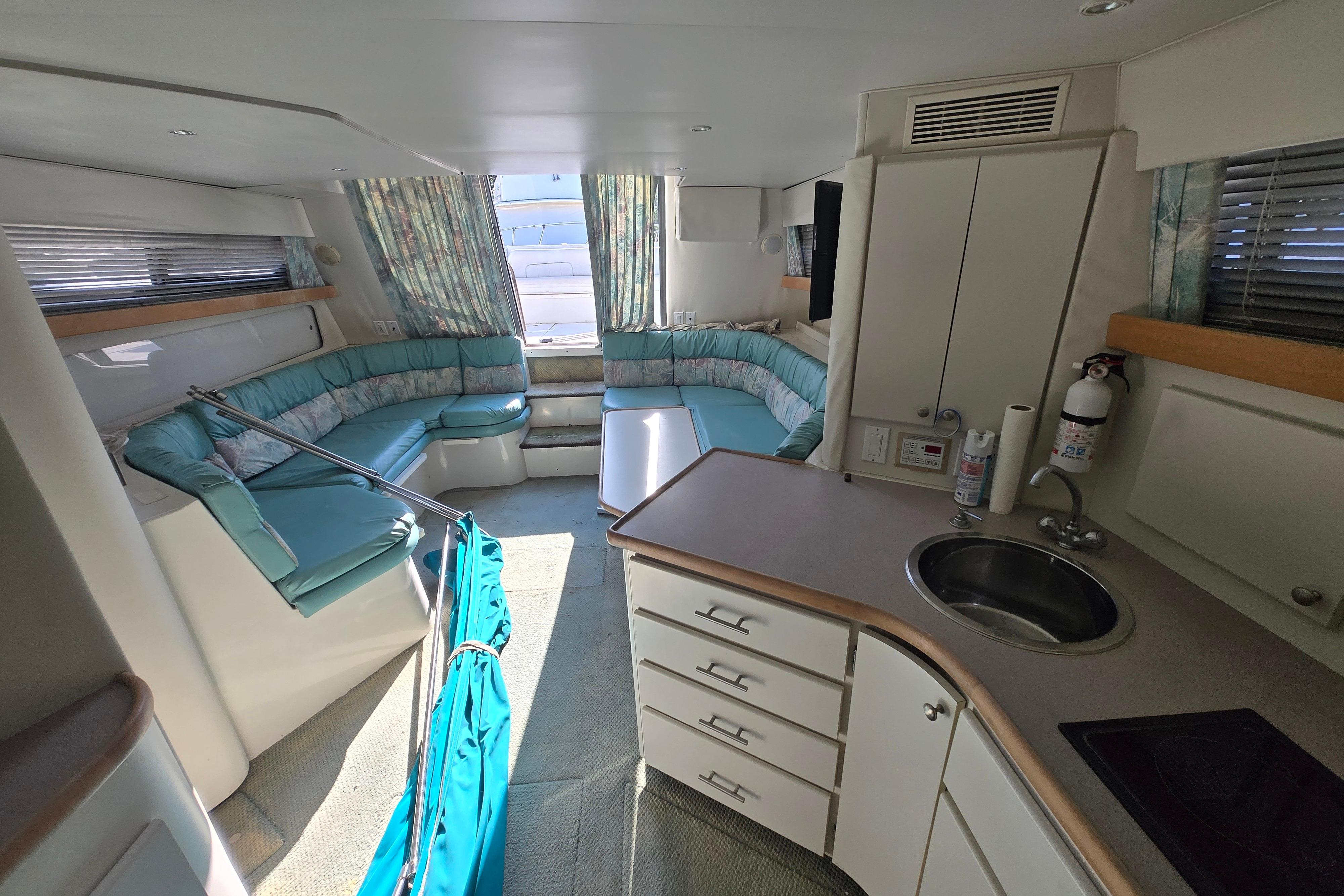 Interior of a 1994 Carver 380 Santego yacht with seating and kitchenette.