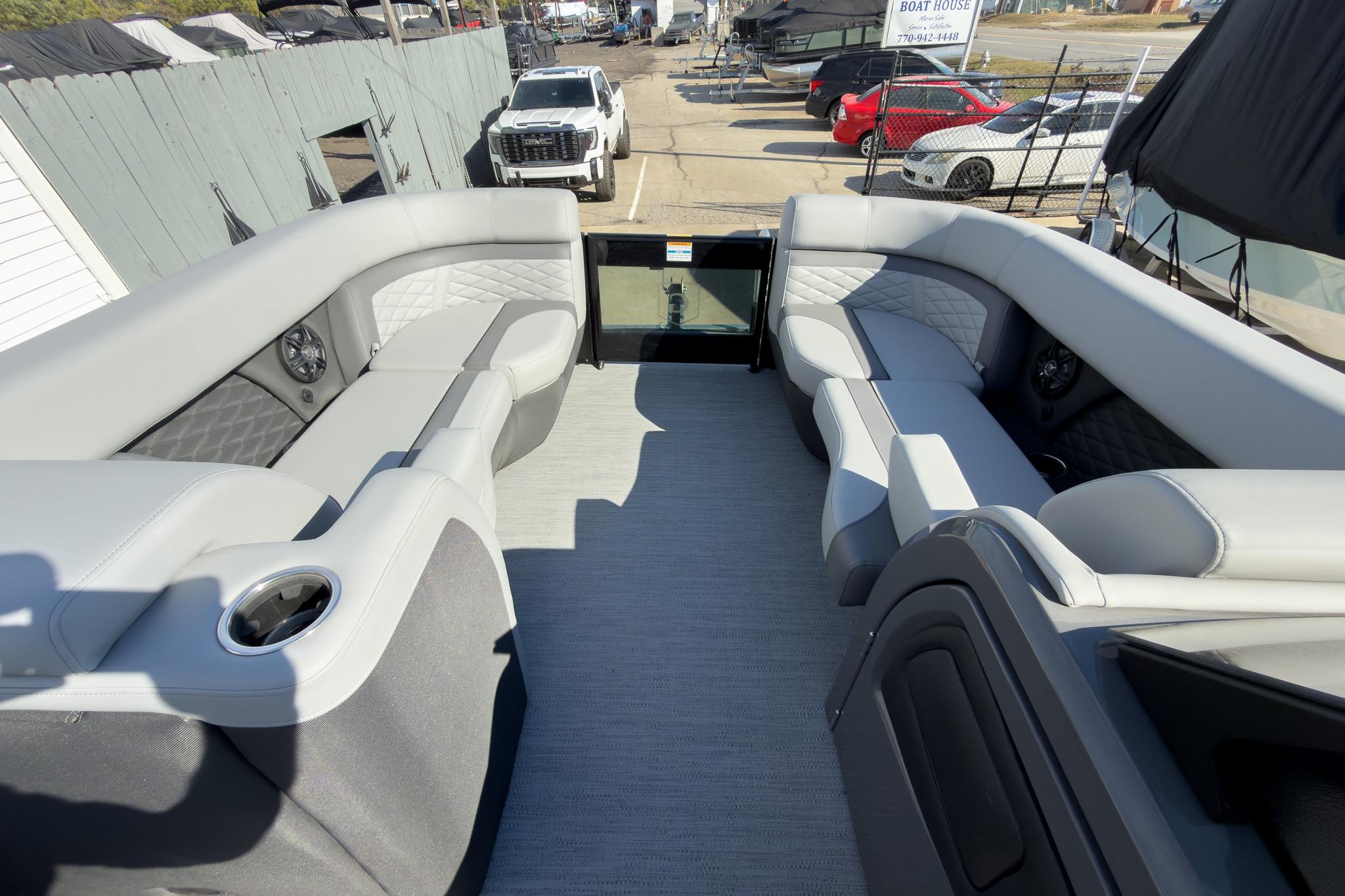 2026 Godfrey Monaco 235 Split Bench boat interior with gray seating and cup holders.