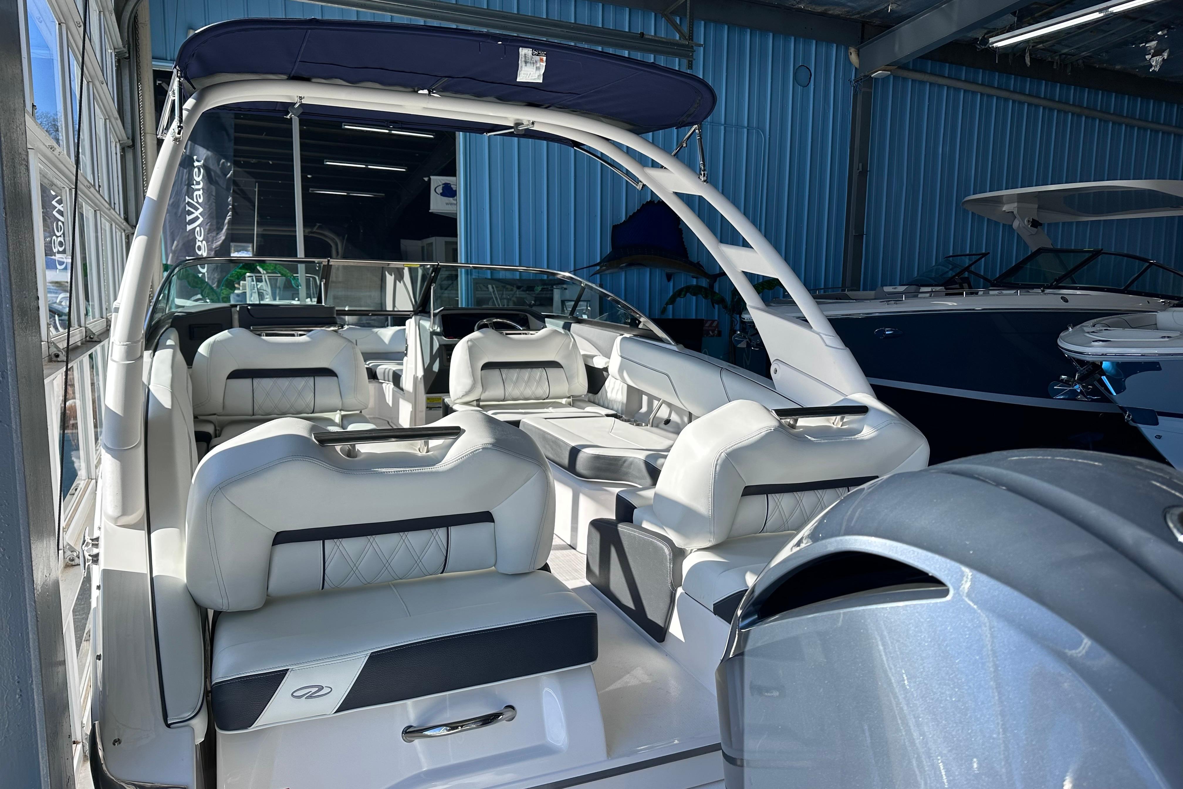 2026 Regal LX4 boat interior with luxurious seating in a showroom.