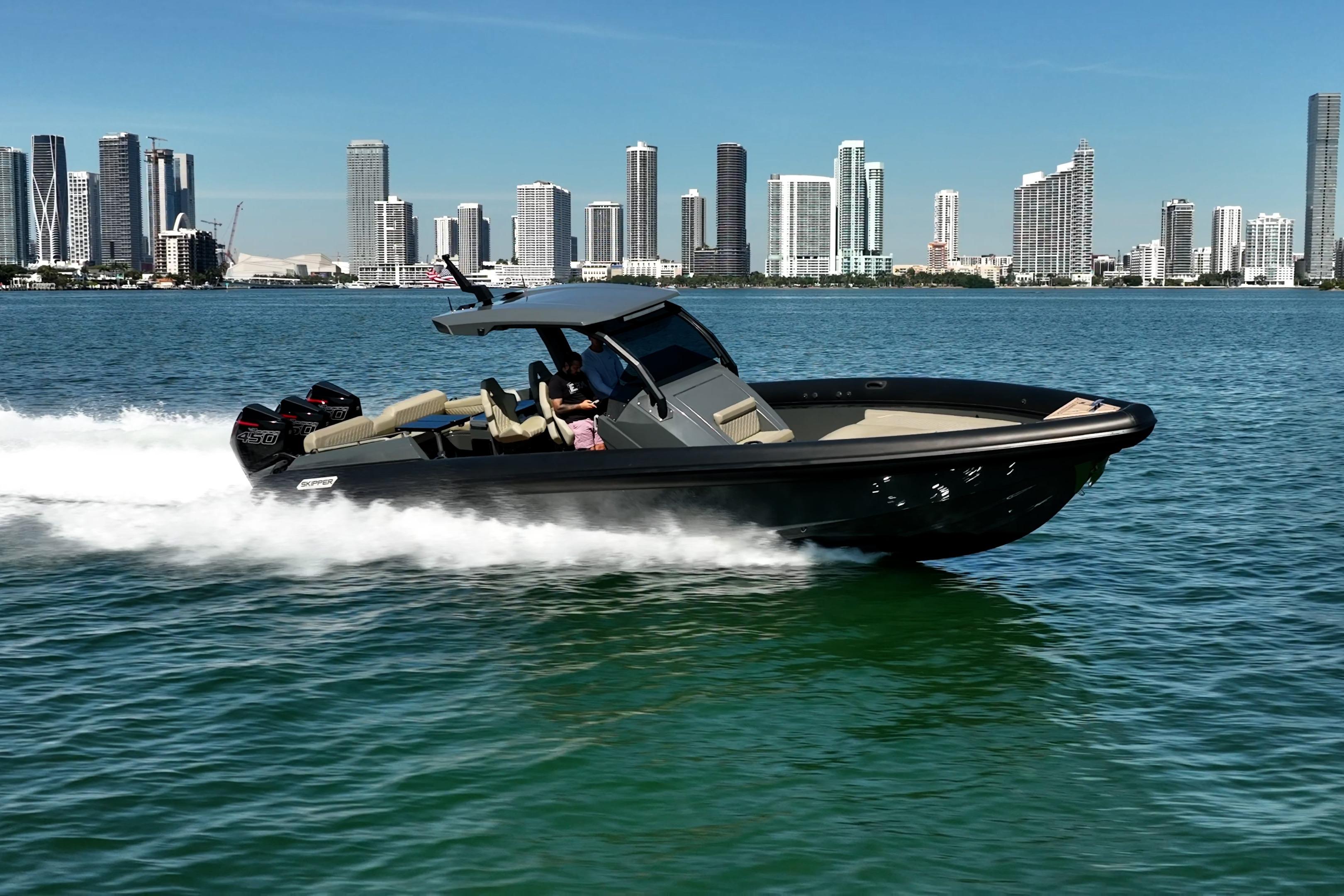 2023 Skipper-BSK 38NC boat cruising on water with city skyline in background.