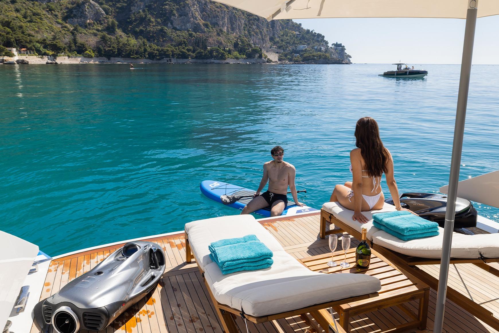 Luxury relaxation on 2024 MandaYachts S05, featuring sunbathing and water activities.