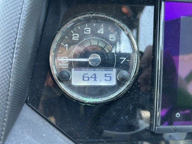 A tachometer displays 64.5 engine hours.