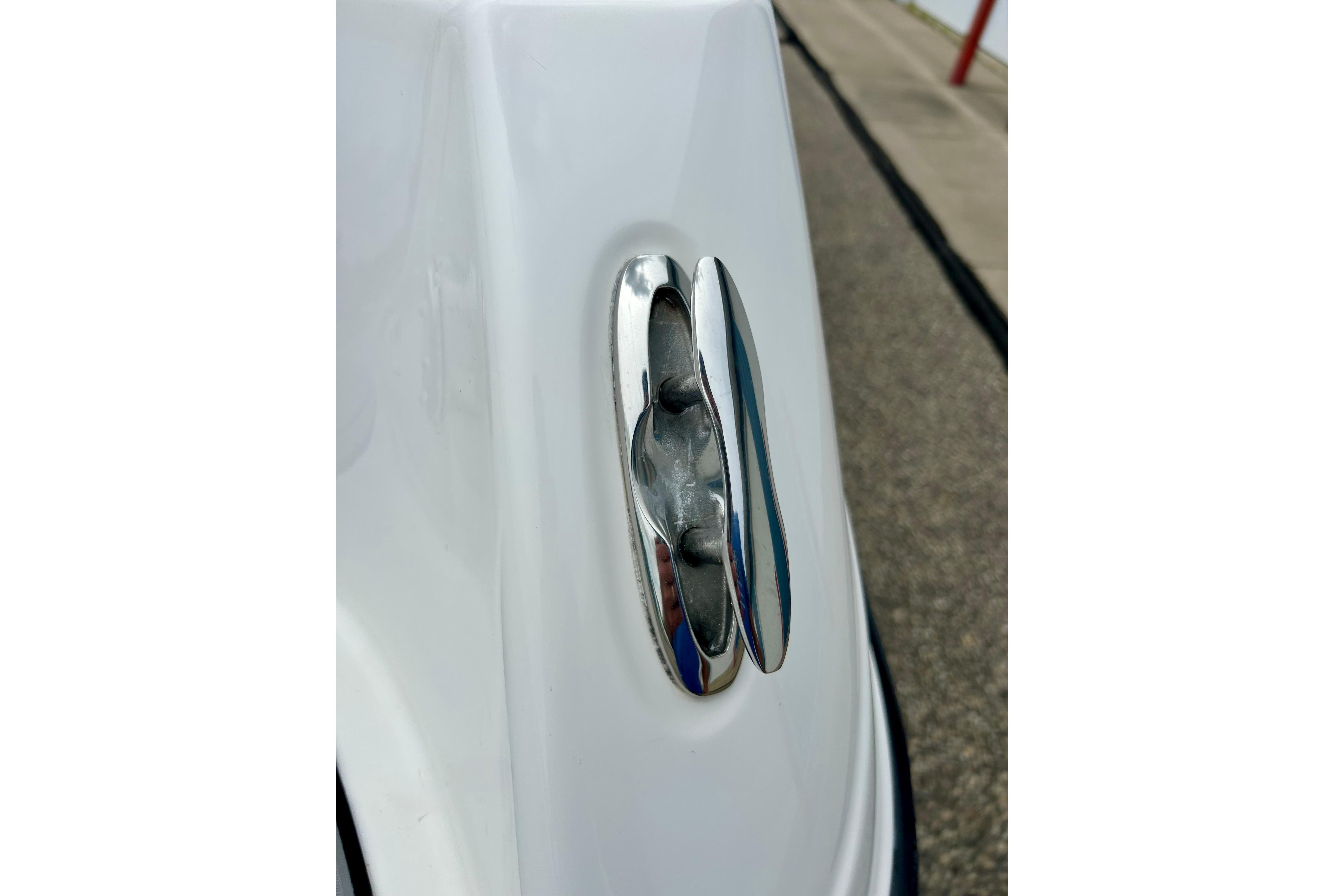 Close-up of a 2015 Yamaha AR210 boat cleat on a white surface.