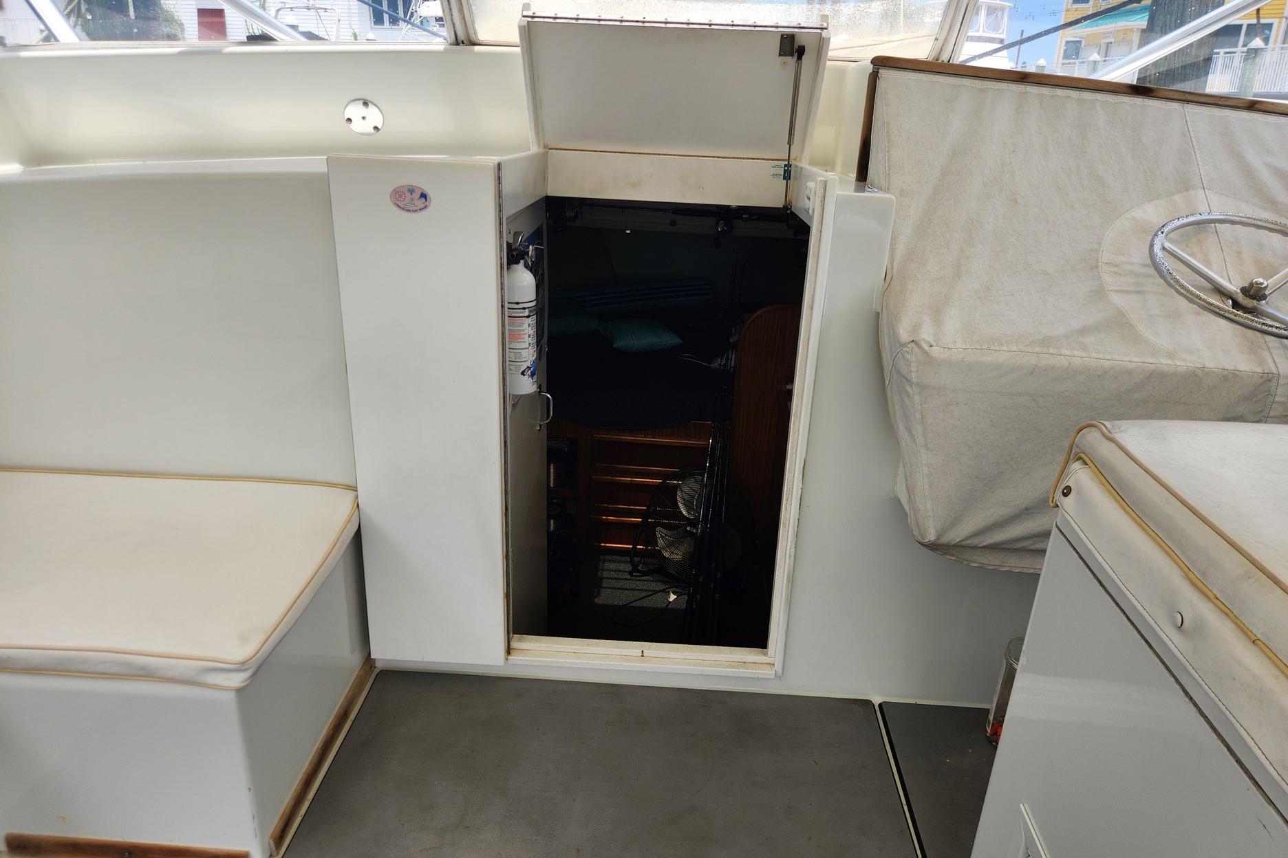 Interior view of 1987 Young Brothers Custom Sport Fish boat, showing cabin entrance and seating.