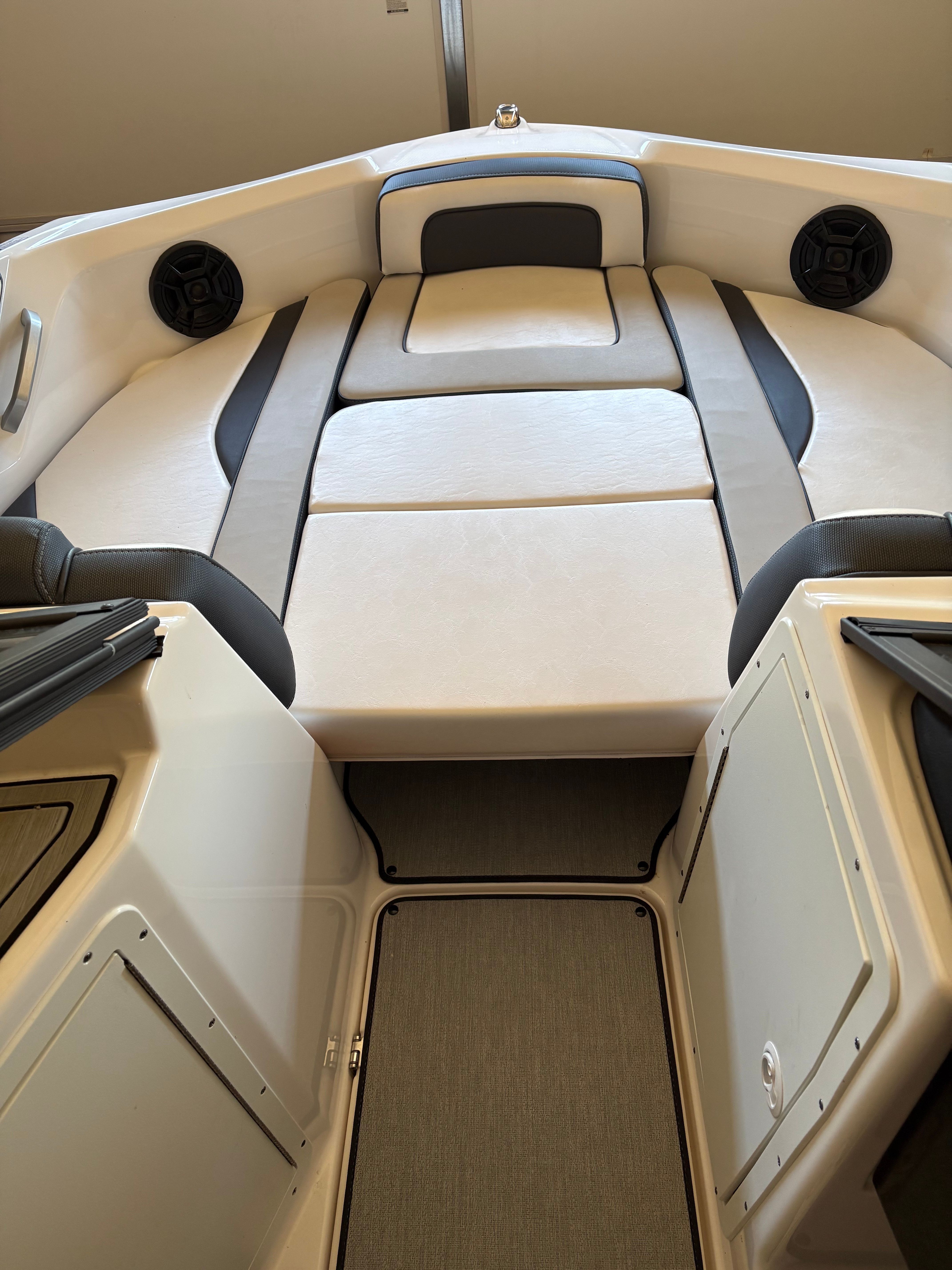 Interior view of a Yamaha AR195 boat with cushioned seating and speakers.