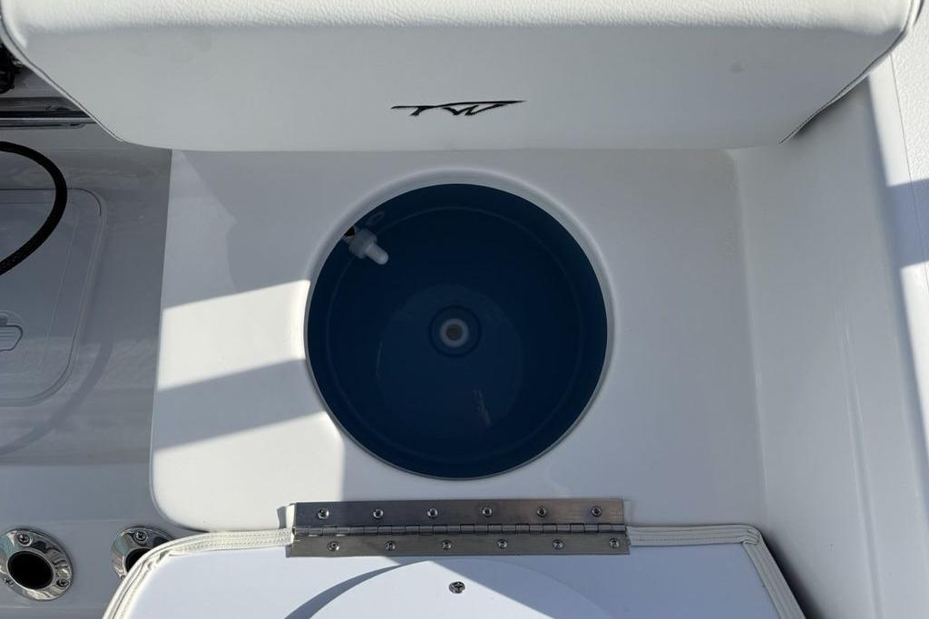 2026 Tidewater 198 CC Adventure boat livewell with white seating and blue interior.