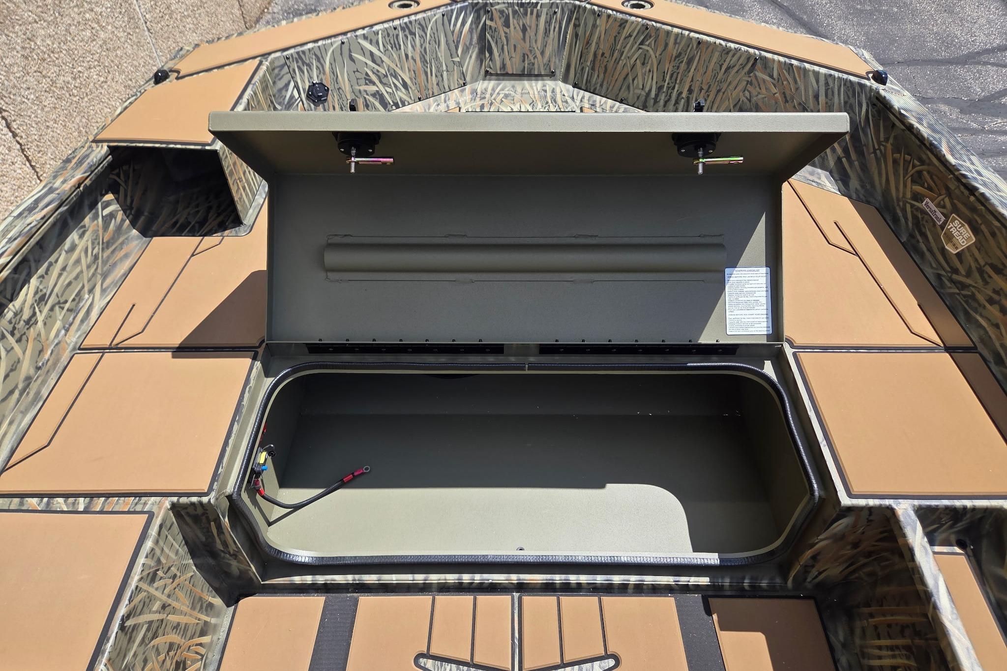 2026 Tracker Grizzly 1756 T Marsh boat interior with open storage compartment.