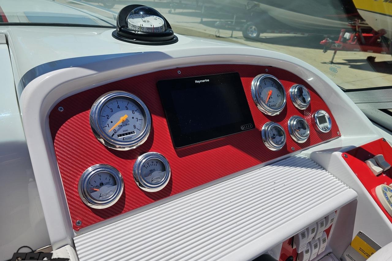 Dashboard of a 2005 Formula 271 FASTech boat with gauges and a compass.