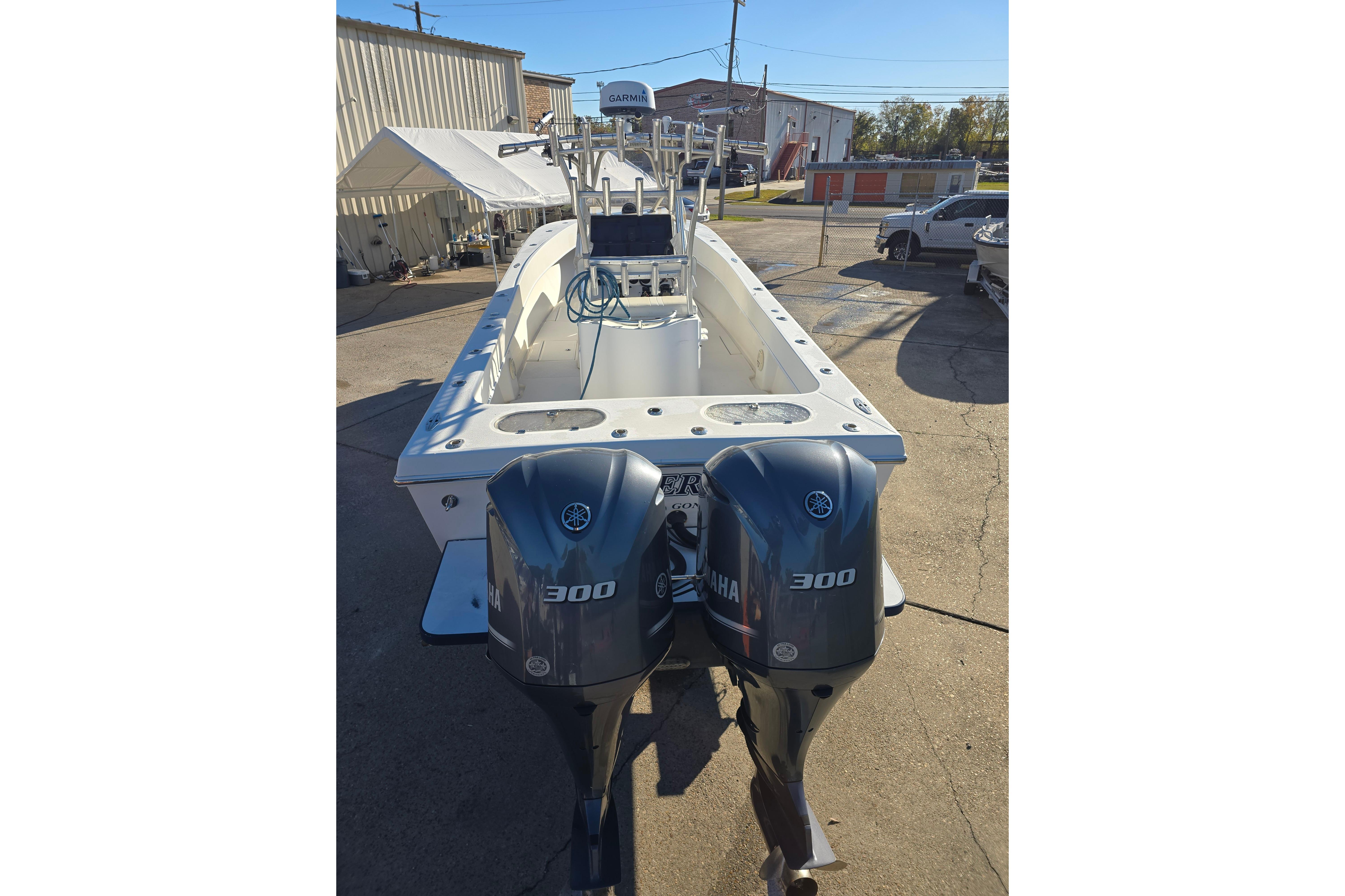 2007 Competition 31 boat with dual Yamaha 300 engines, parked outdoors.