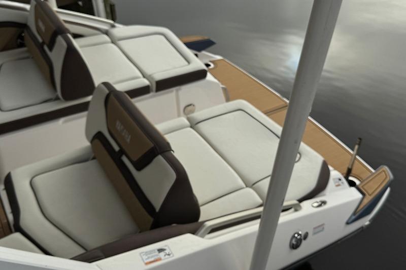 2023 Yamaha 275SDX boat with luxurious seating on calm water.