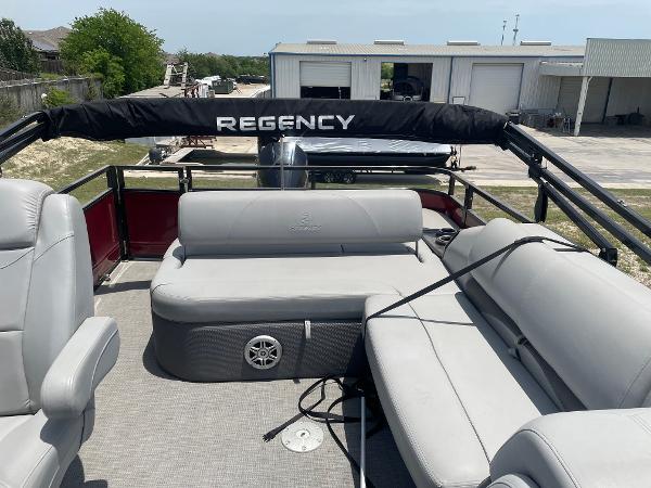 2023 Regency 250 DL3 pontoon boat with spacious seating and sleek design.