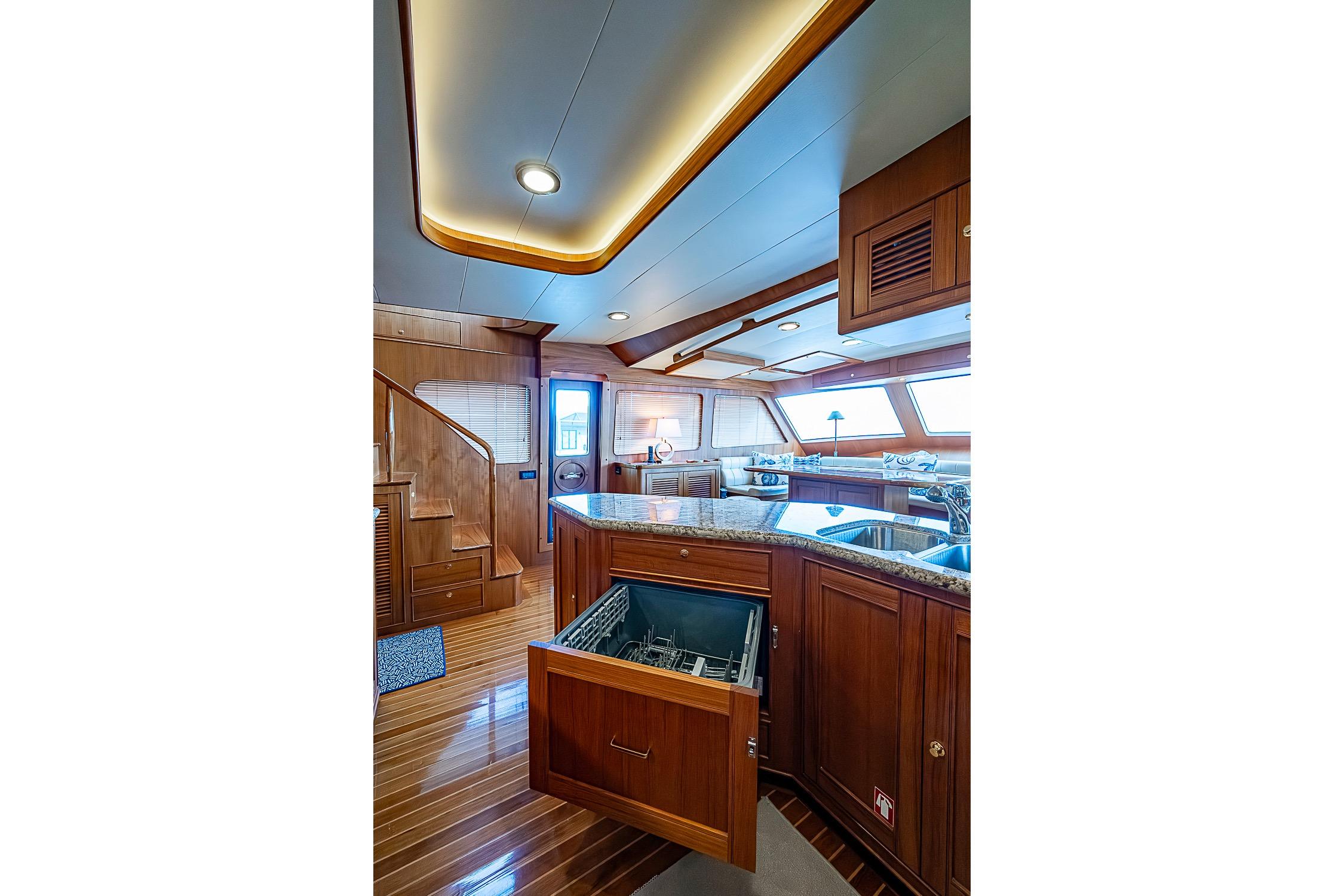 Luxurious interior of 2014 Marlow 80 Explorer yacht with modern kitchen and wooden finishes.