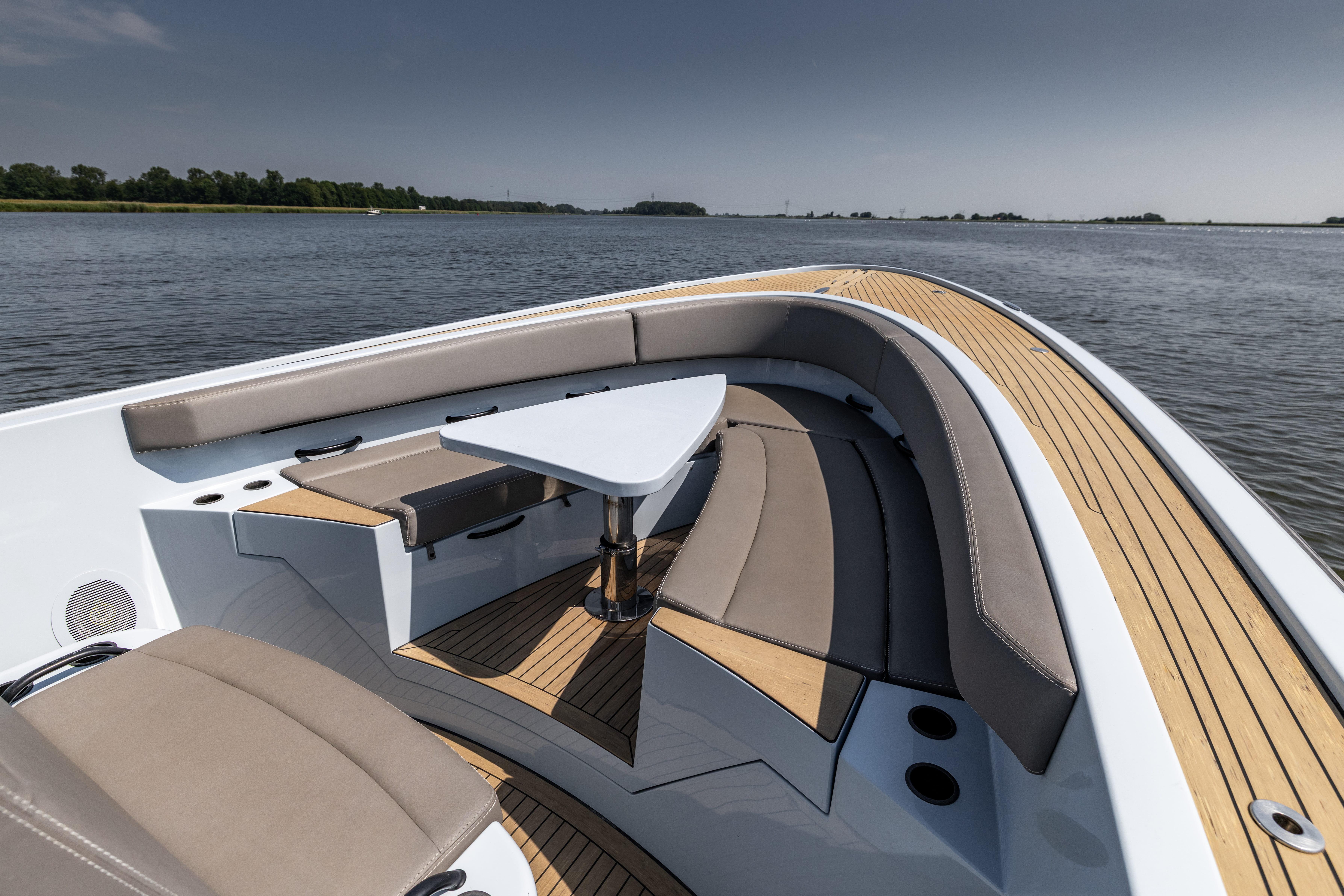 Luxurious 2017 Wajer 38 yacht interior with elegant seating and table on calm water.