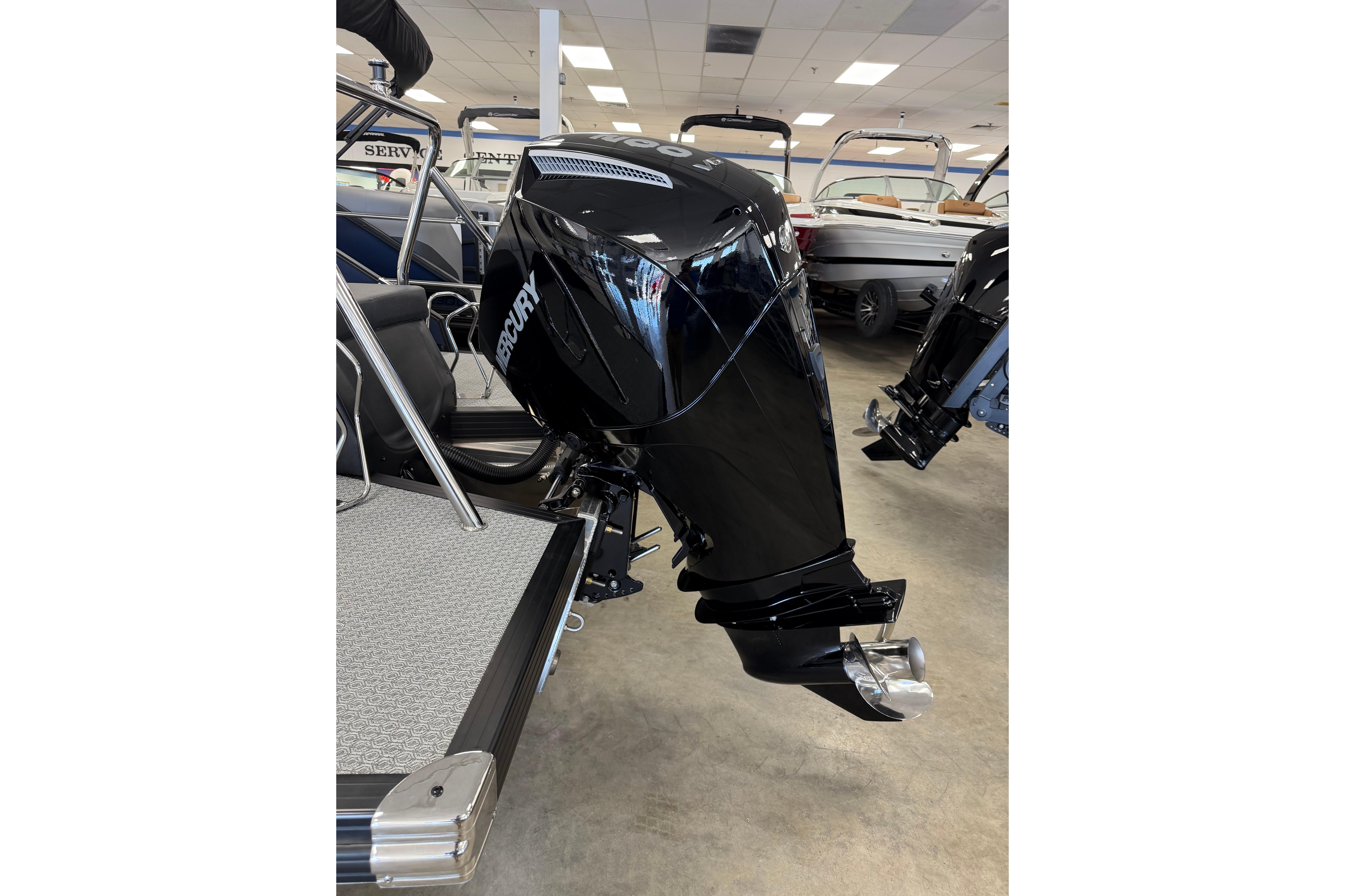 2026 Evotti 721CS boat with Mercury outboard motor in showroom.