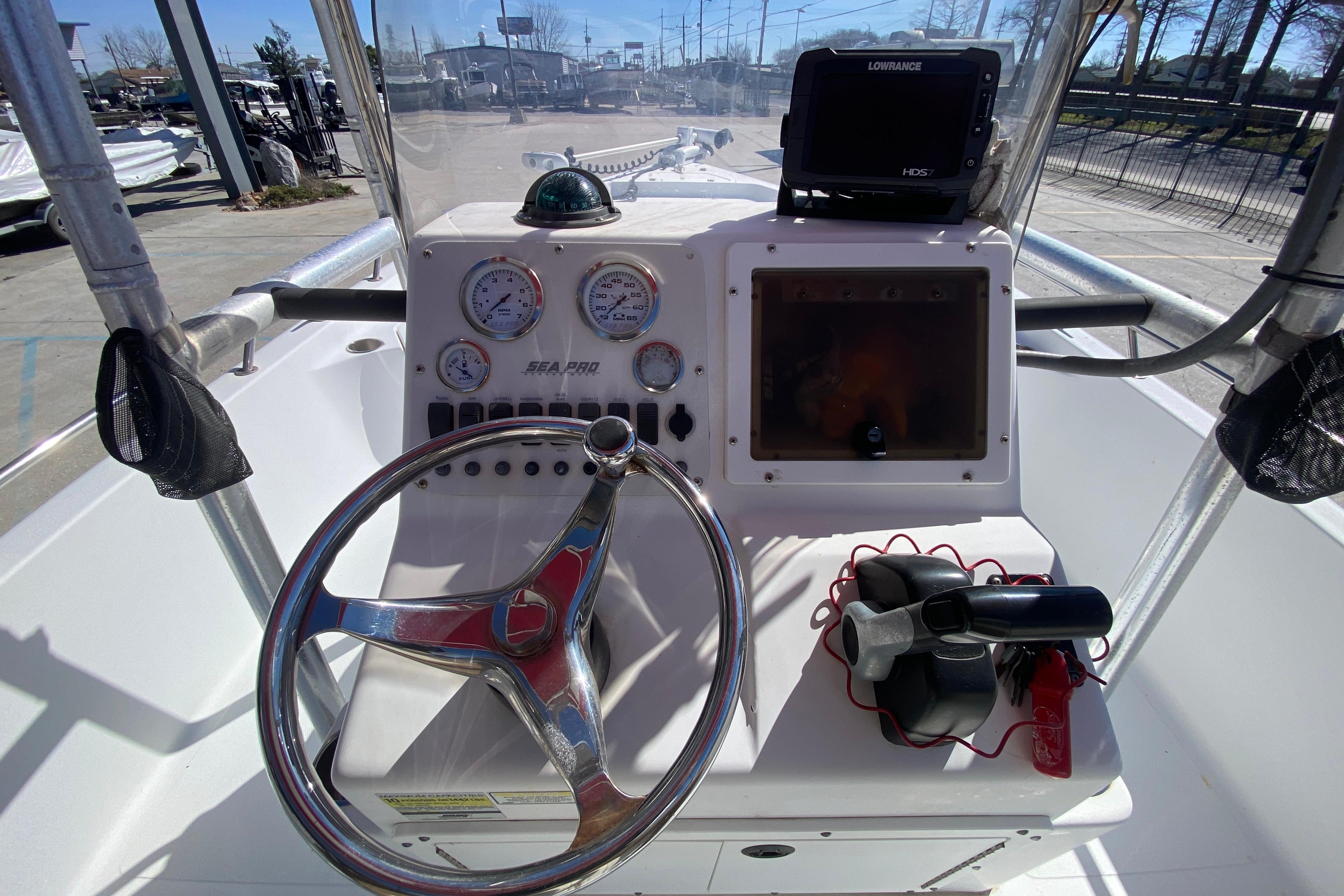 2005 Sea Pro SV2400CC Bay Boat dashboard with steering wheel and navigation equipment.