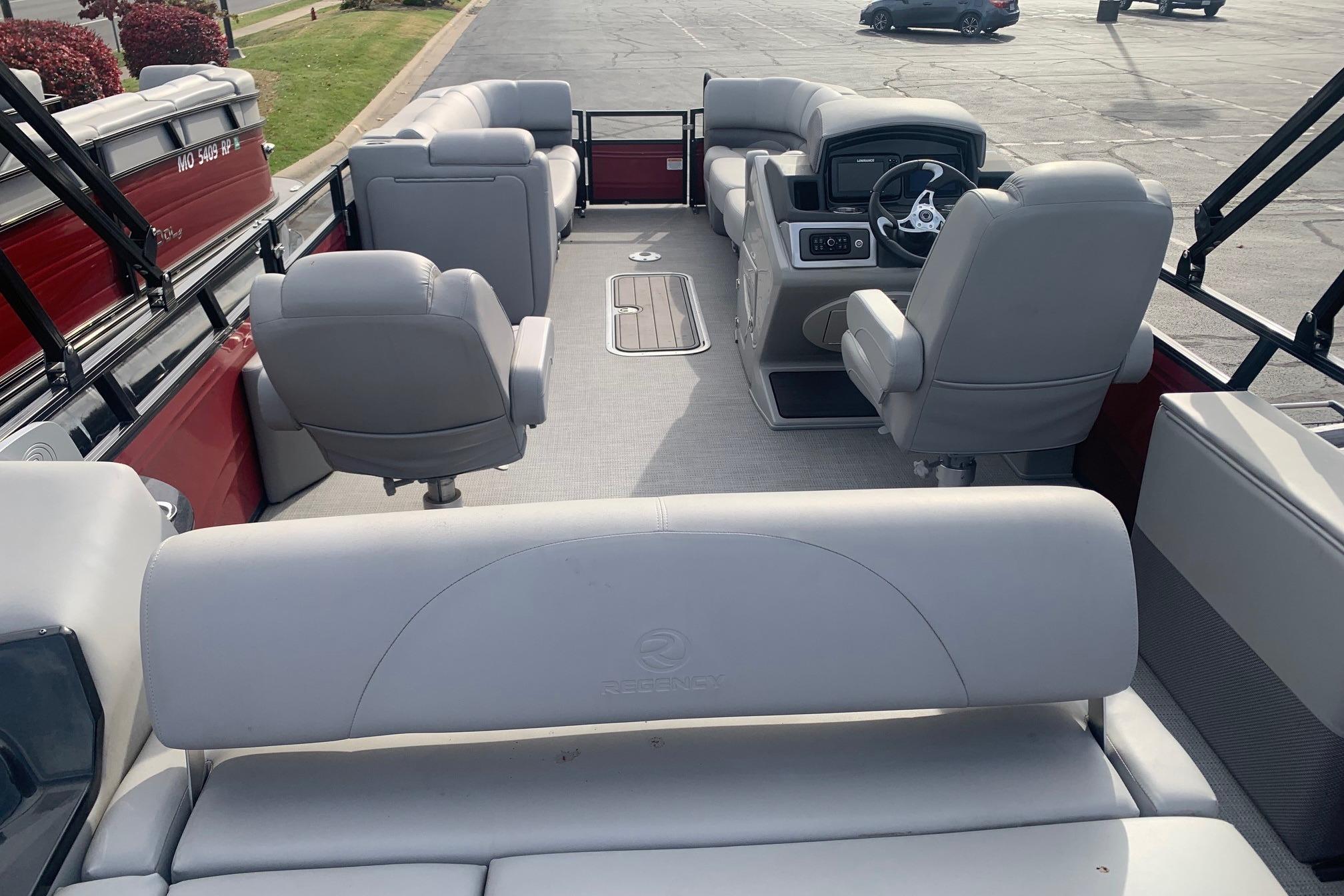 2024 Regency 250 DL3 pontoon boat interior with plush seating and modern dashboard.