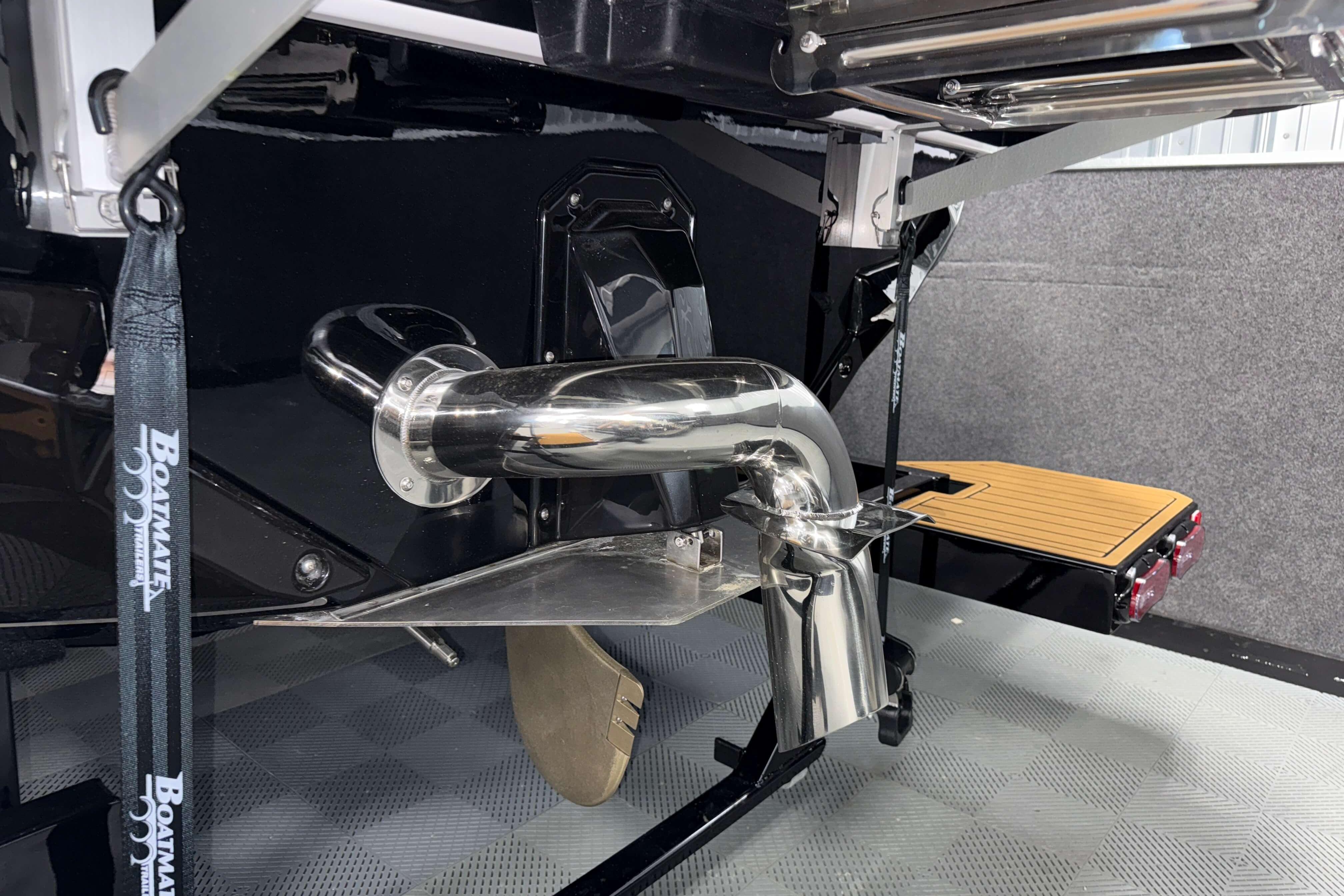 2026 Nautique Super Air Nautique S23 boat exhaust and propeller detail.