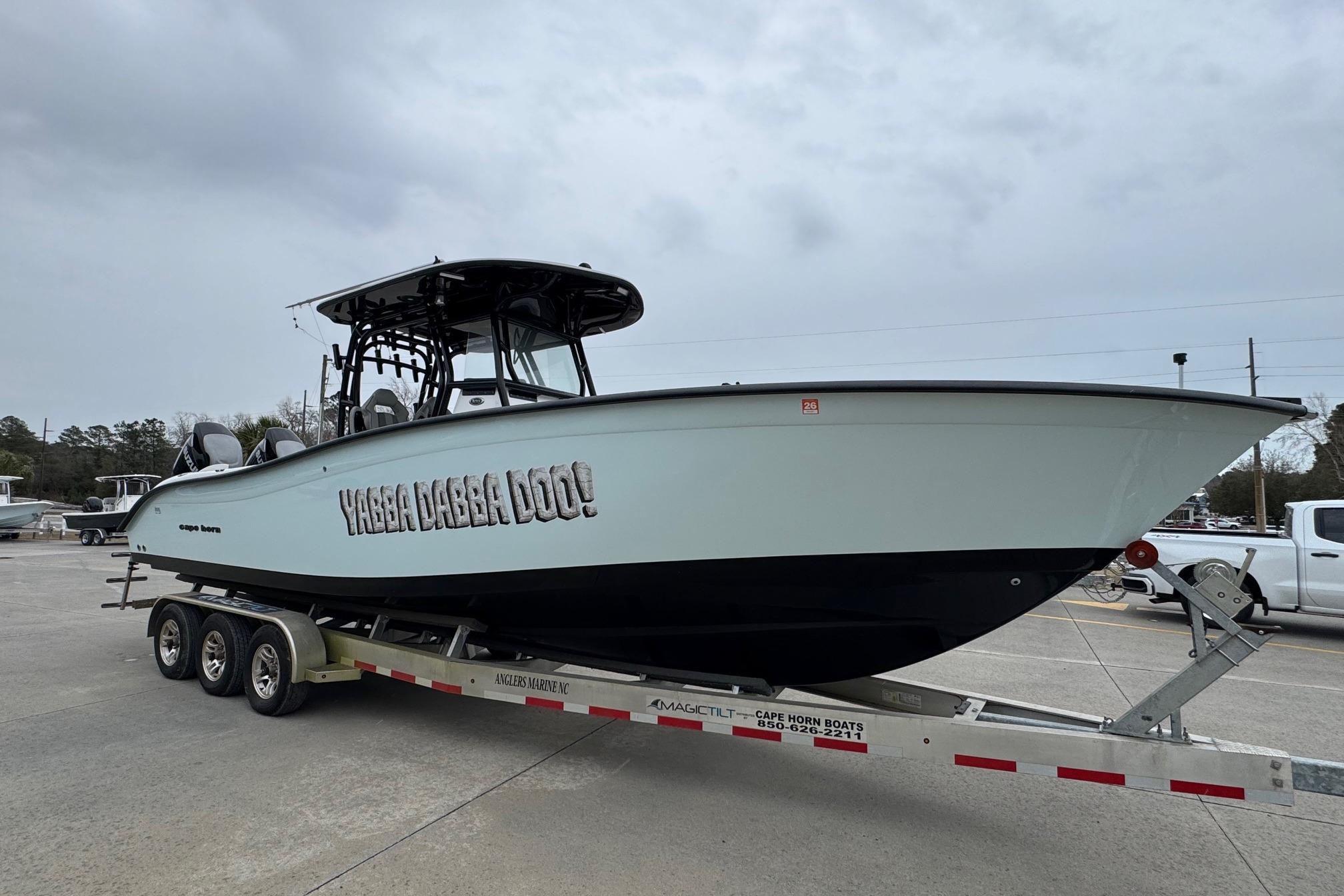 2024 Cape Horn 32 XS boat on trailer, side view with "Yabba Dabba Doo!" text.
