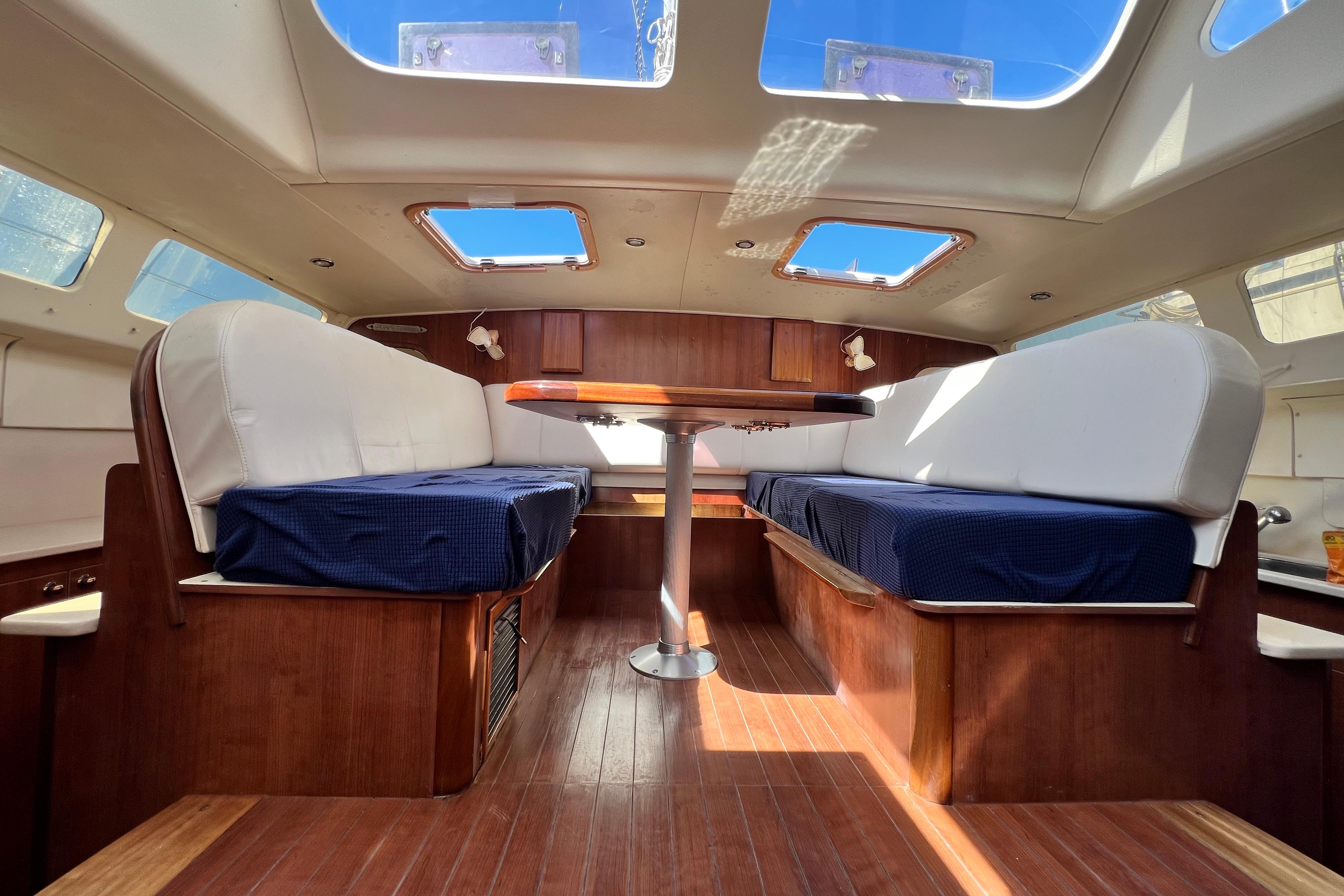 Interior of 2013 Gemini Legacy 35 catamaran with skylights and wooden furnishings.