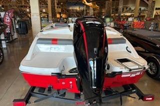 2026 Tahoe T18 boat with outboard motor in showroom setting.