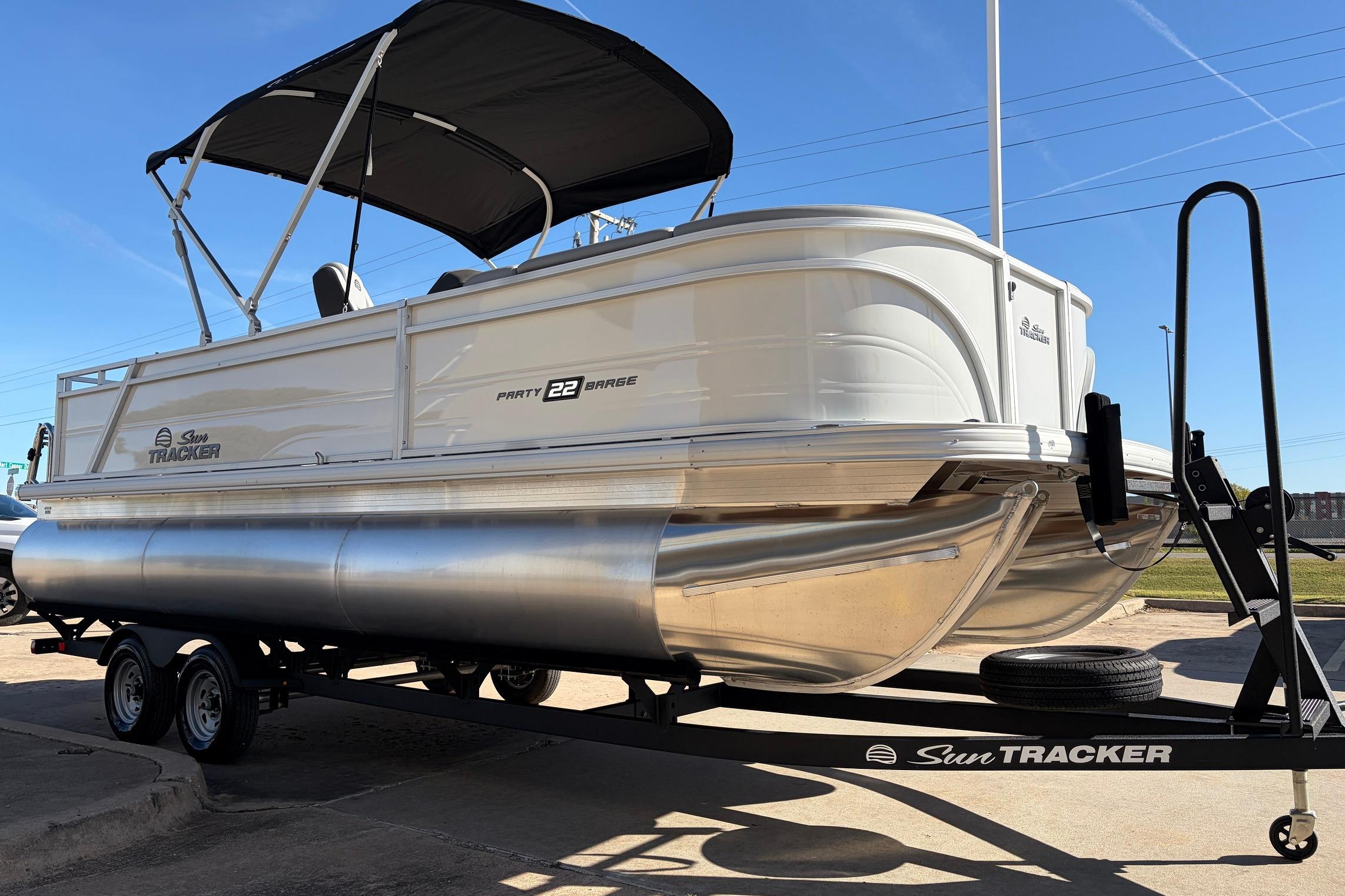 2026 Sun Tracker Party Barge 22 RF XP3 pontoon boat on trailer, side view.