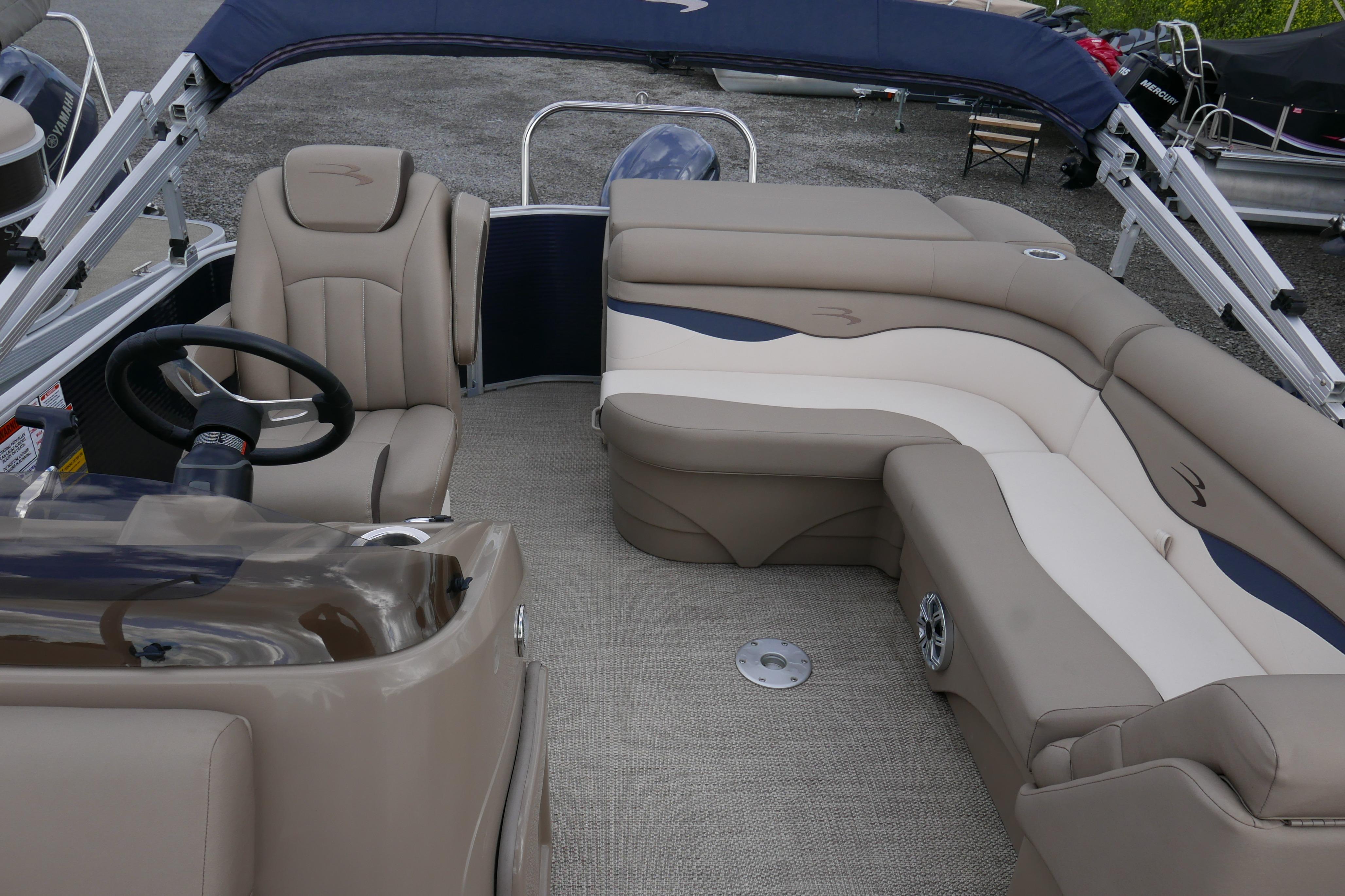 2019 Bennington SX 20 SLXP pontoon boat interior with plush seating and steering console.