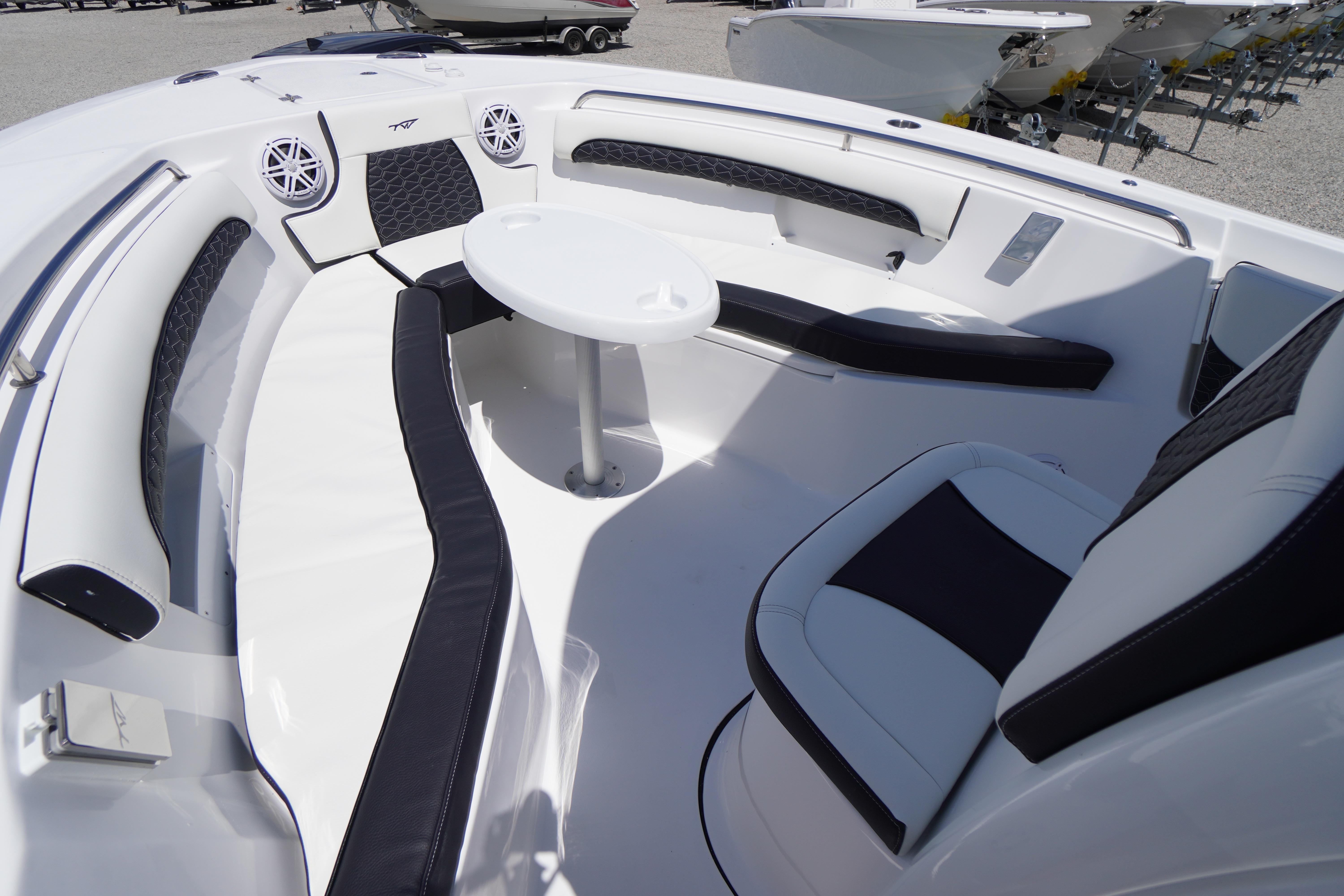 Luxurious seating area on 2026 Tidewater 232 LXF boat with modern design and table.