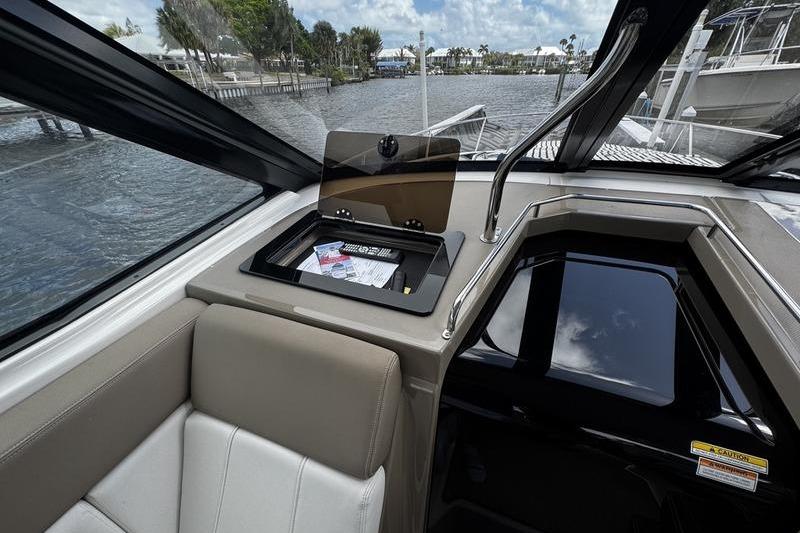 Interior of 2018 Regal 35 Sport Coupe with open storage compartment and water view.