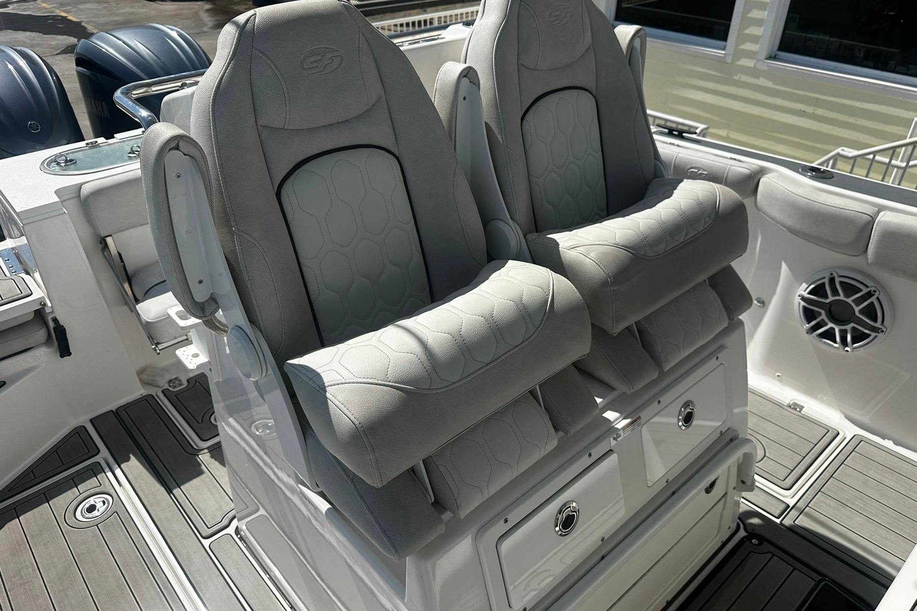 Luxury seating on a 2002 Sea Fox 228 Commander boat, featuring plush gray upholstery.