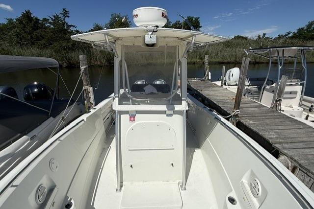 2006 Sailfish 2660 CC boat docked, featuring center console and canopy.