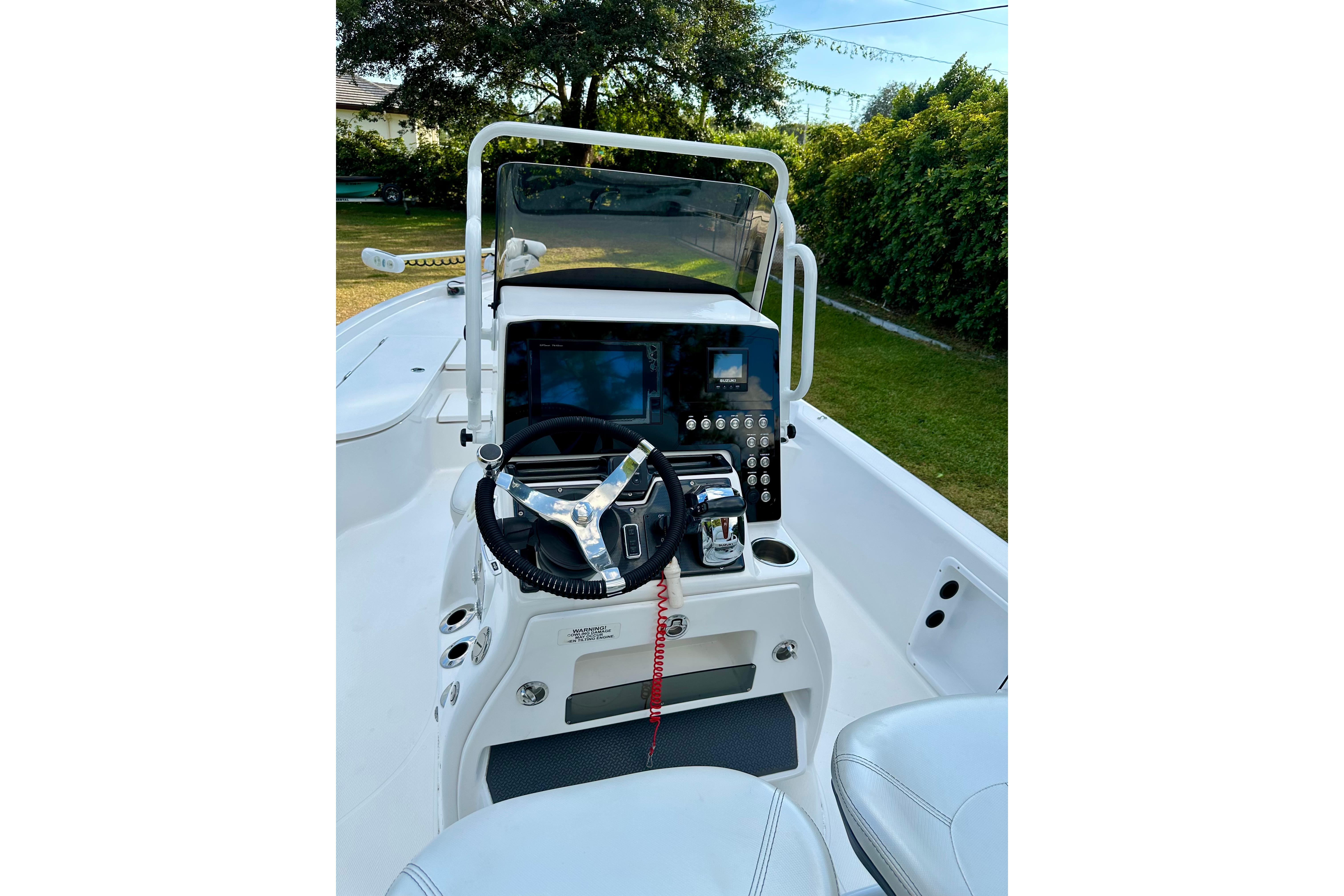 2017 Blue Wave 2400 PureBay boat console with steering wheel and controls.