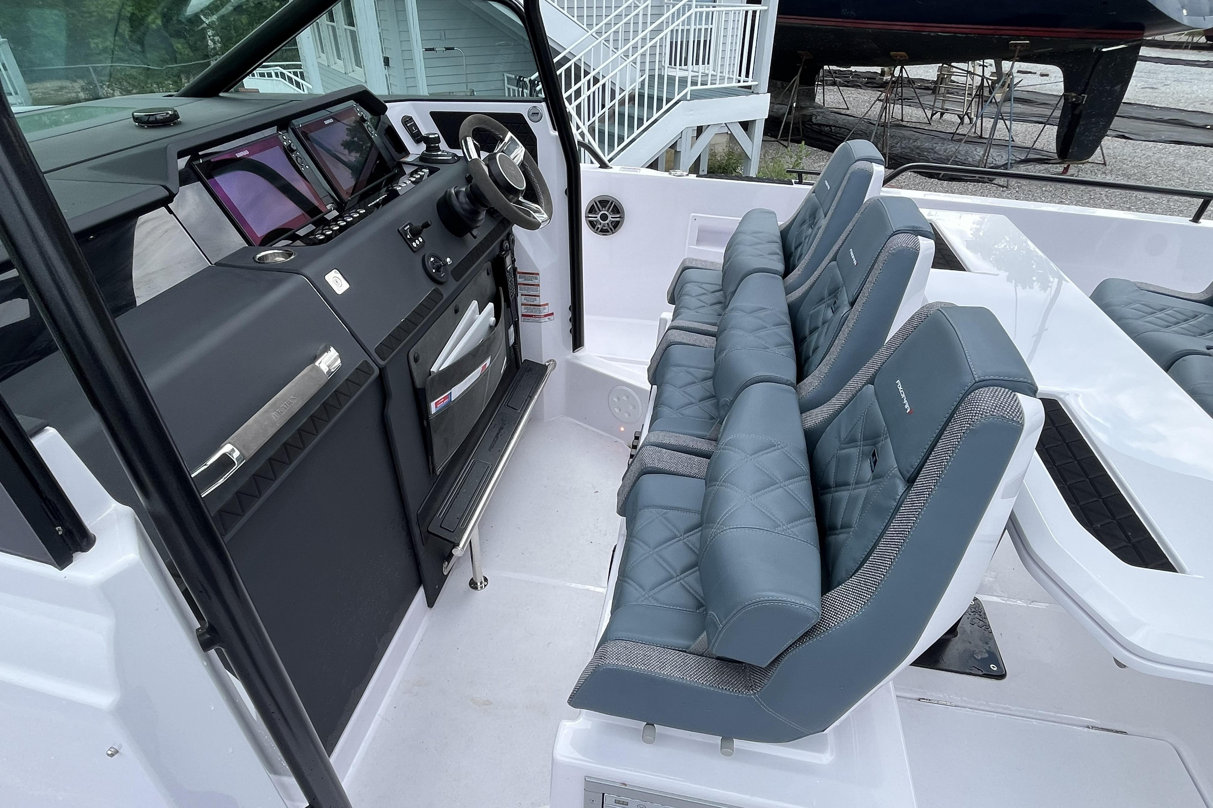 2025 Axopar 37 Sun-Top boat interior with modern dashboard and luxurious seating.