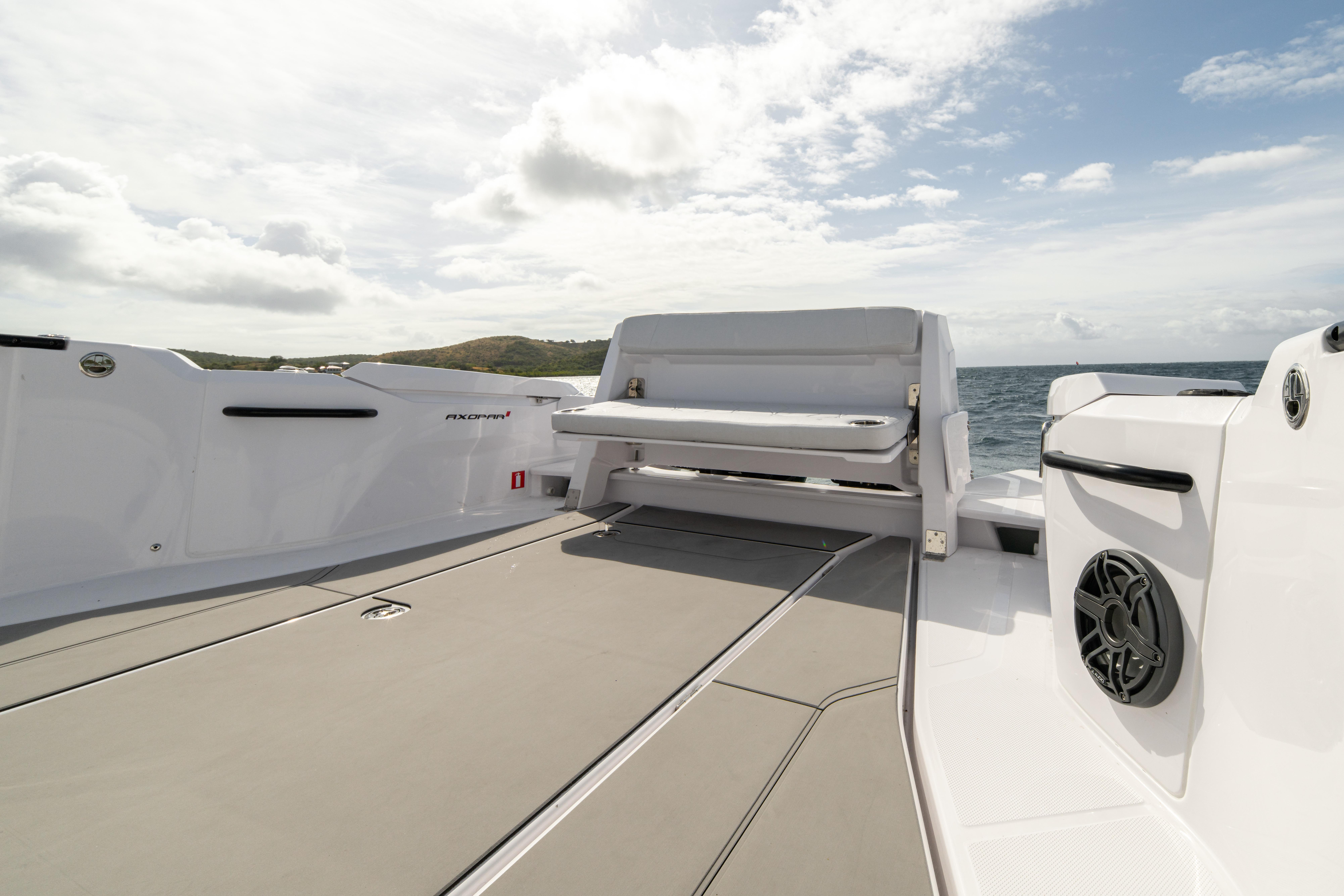 2025 Axopar 29 CCX boat deck with seating, ocean view, and clear sky.