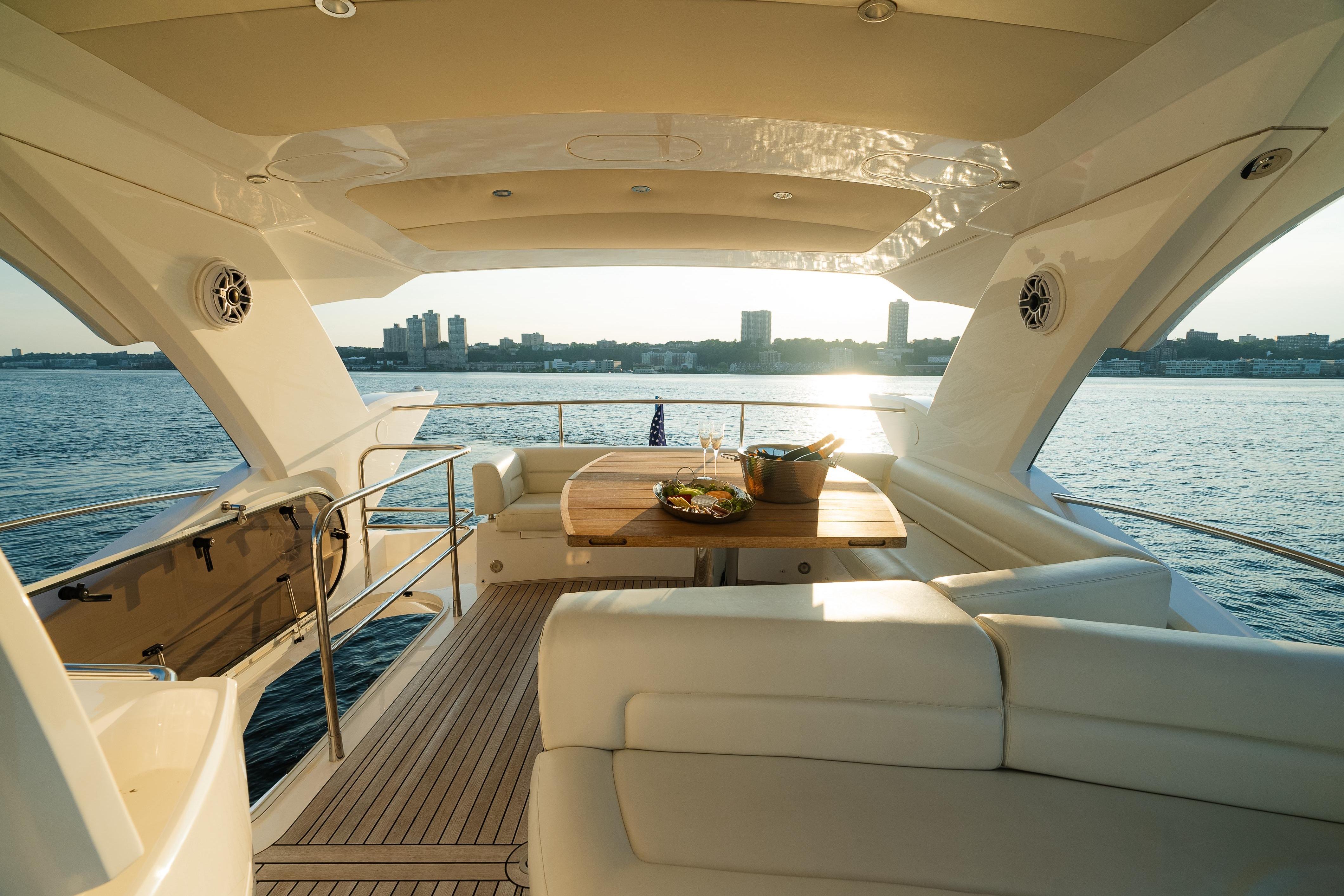 Luxurious 2016 Sunseeker Manhattan 65 yacht interior with elegant seating and ocean view.