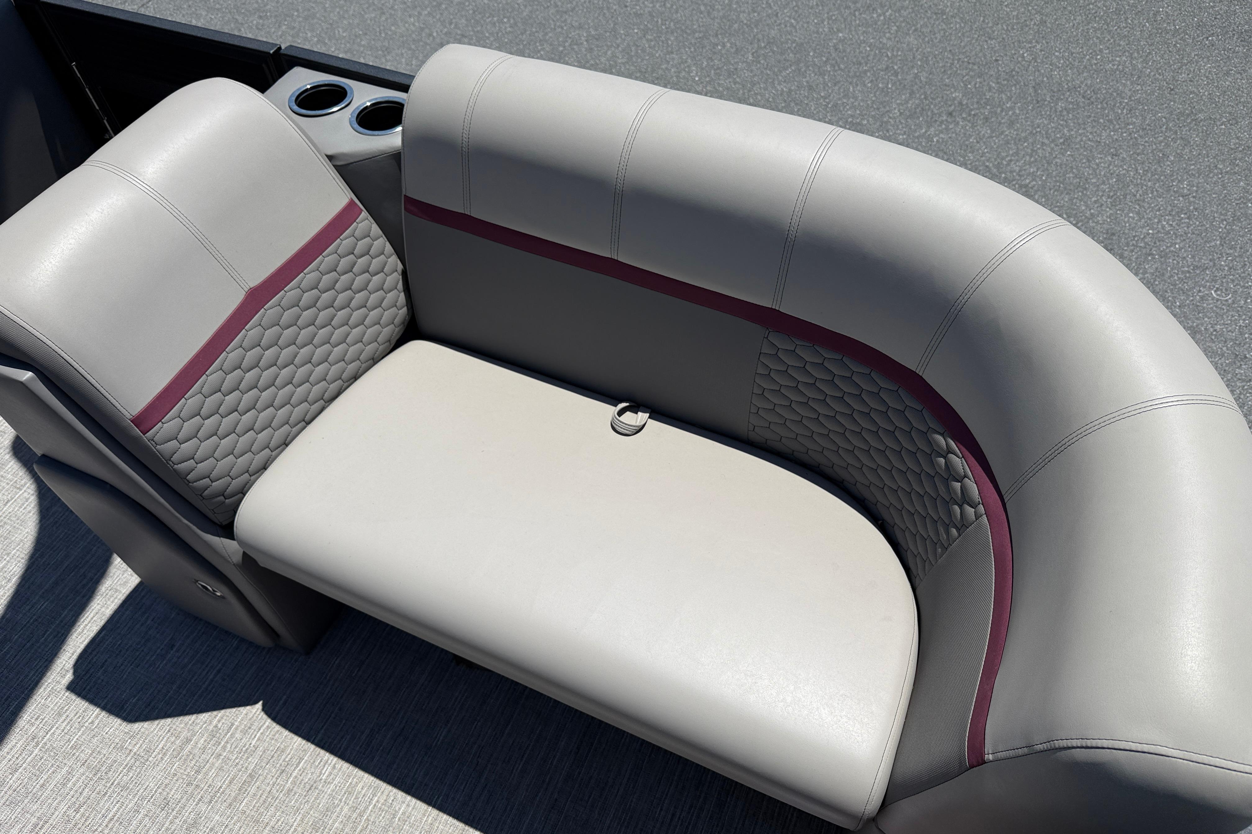Luxurious seating on 2023 Apex 818 boat with textured upholstery and cup holders.