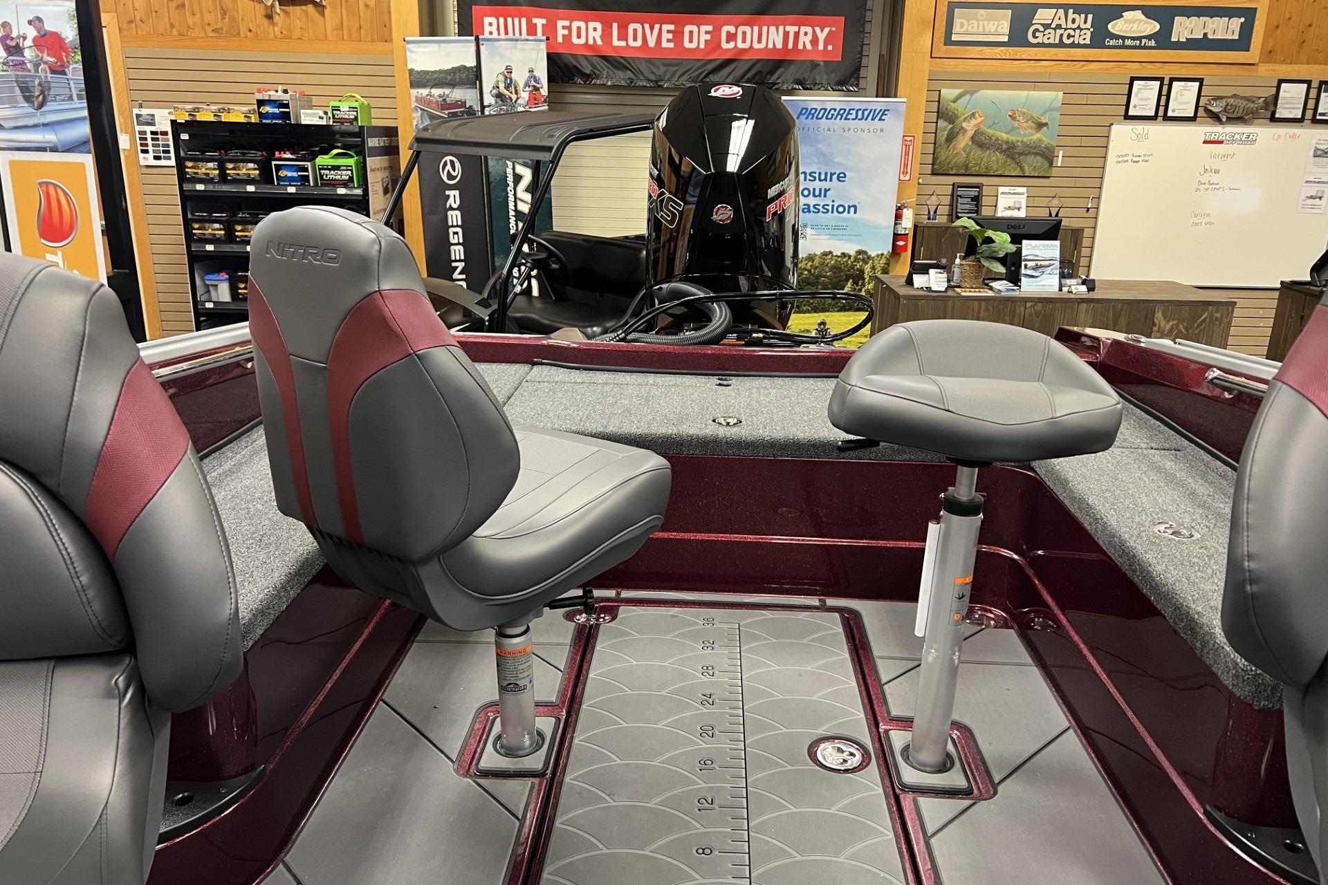 2026 Nitro ZV20 Pro boat interior with gray and maroon seating in showroom.