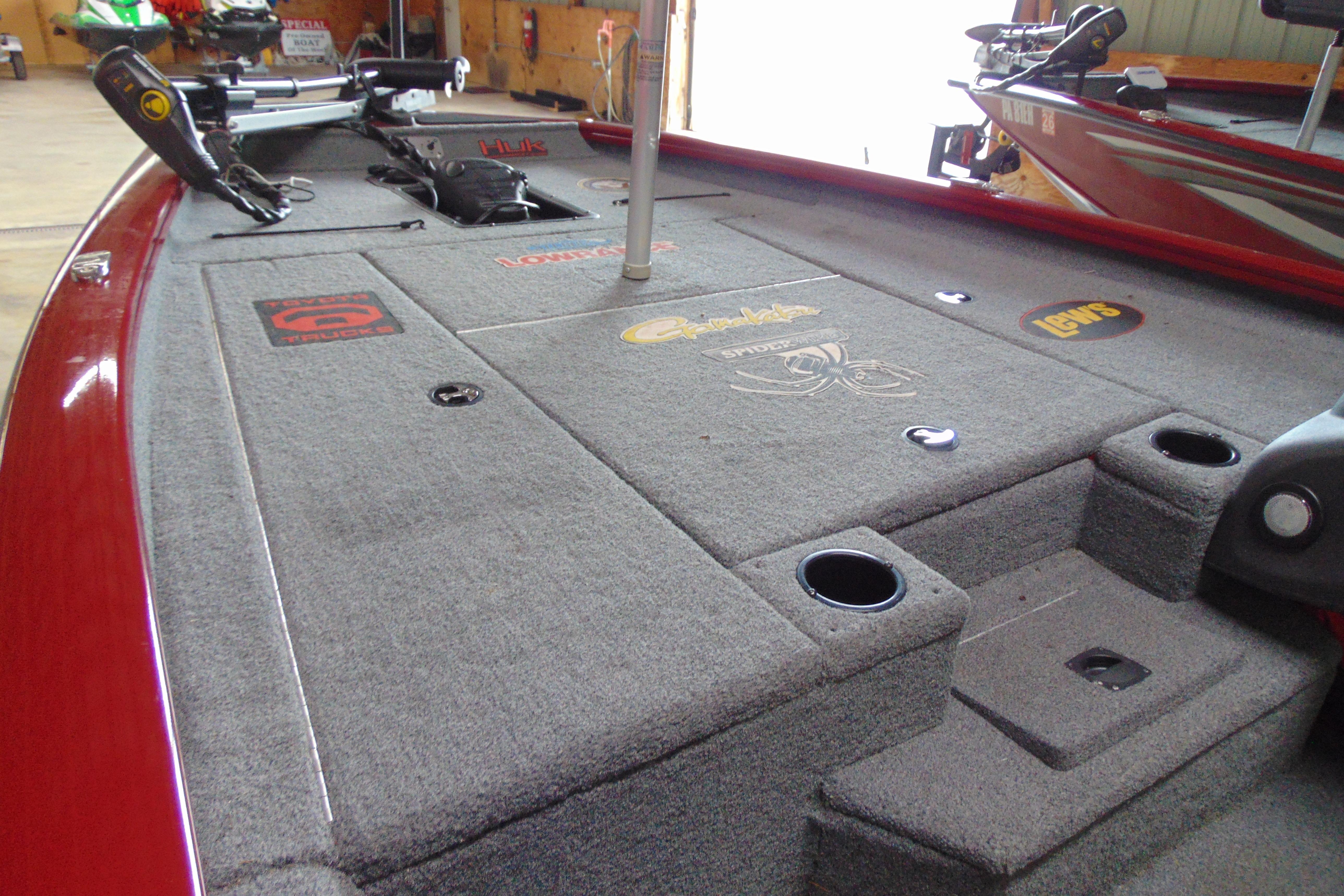 2022 Bass Tracker Pro 17 boat interior with carpeted deck and fishing rod holders.