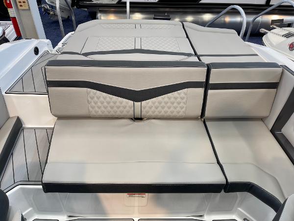 2025 Monterey 218 SS boat interior with stylish, cushioned seating in beige and black accents.
