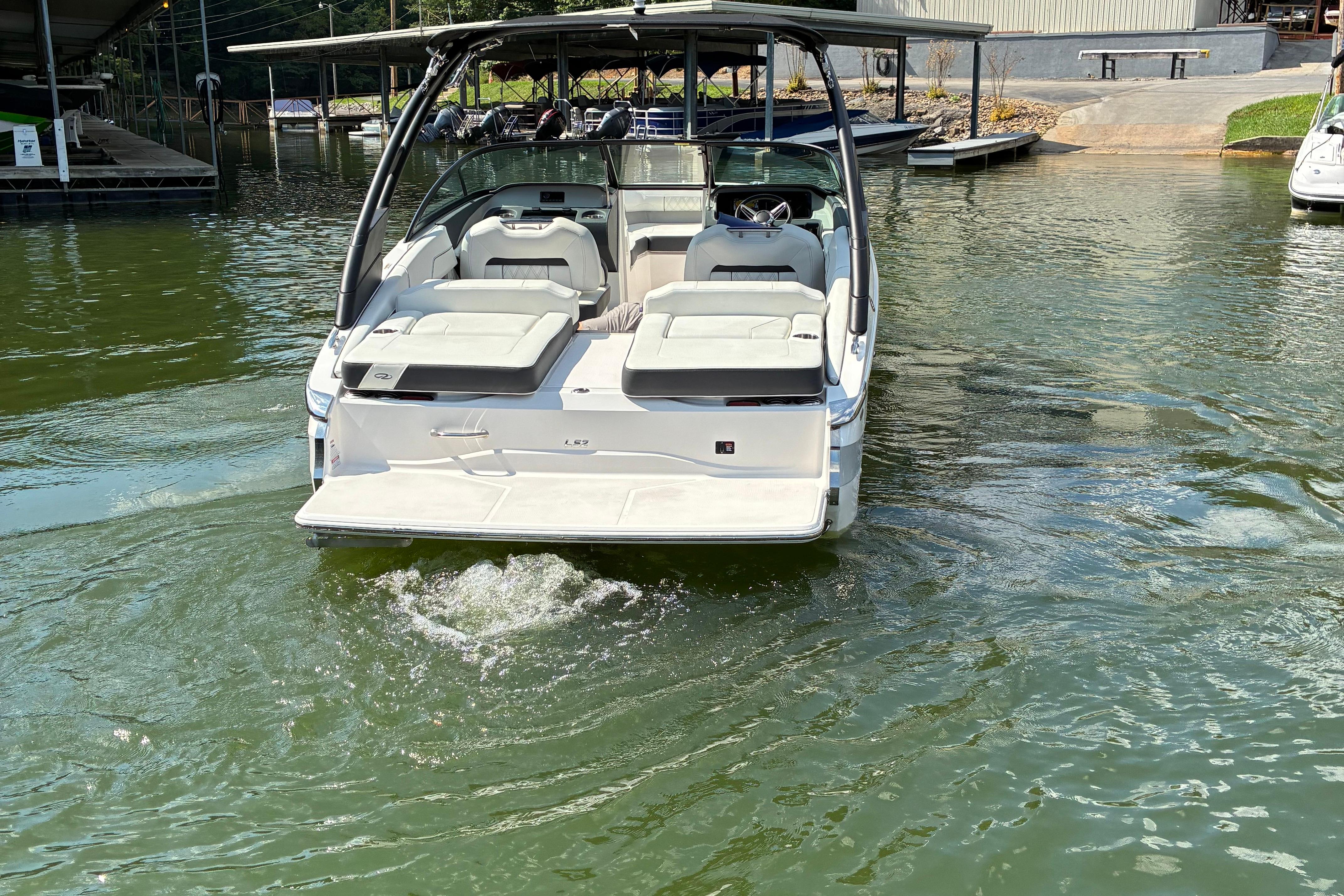 2025 Regal LS2 boat on water, rear view with seating and canopy.