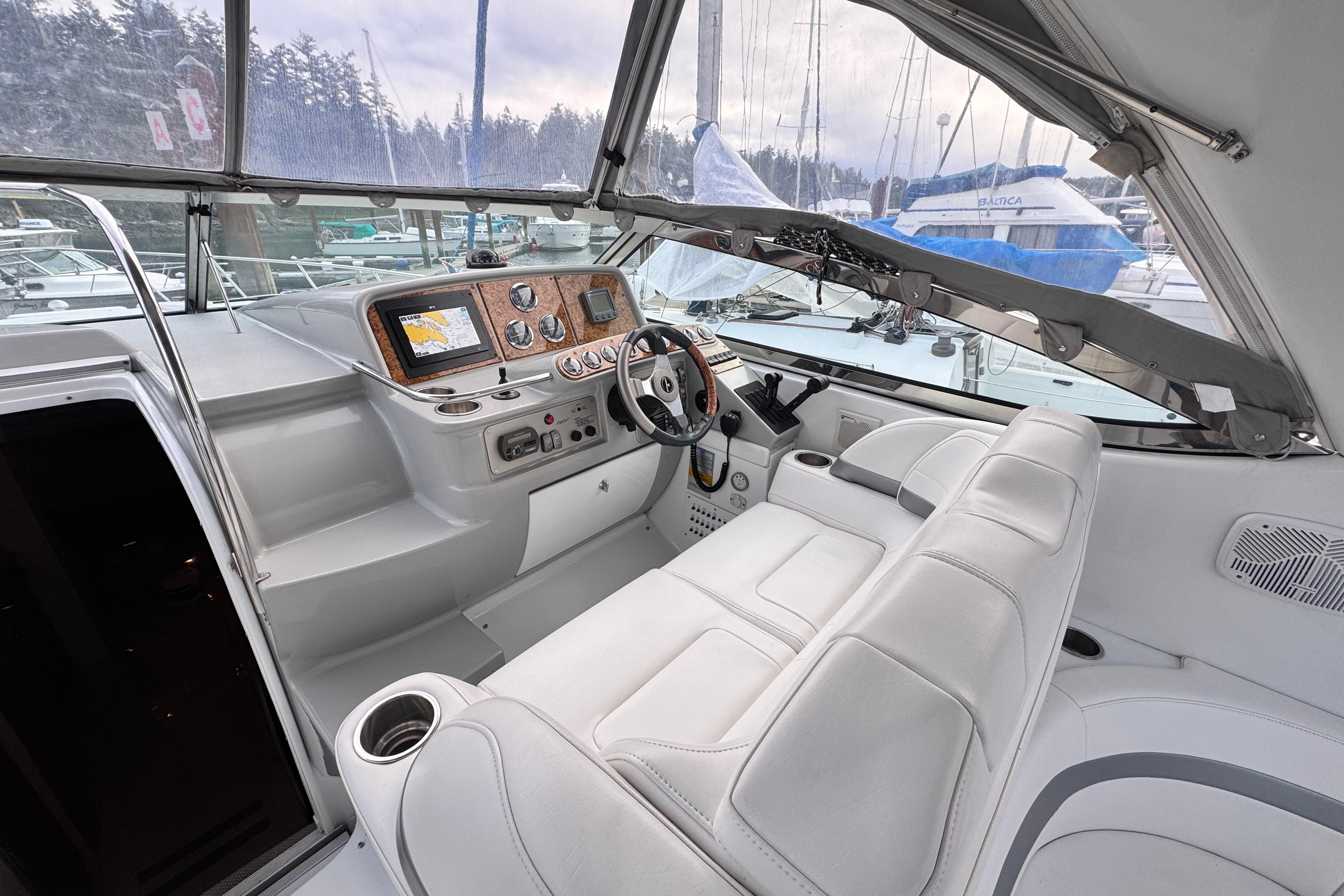 2006 Formula 37 Performance Cruiser cockpit with modern navigation equipment and plush seating.