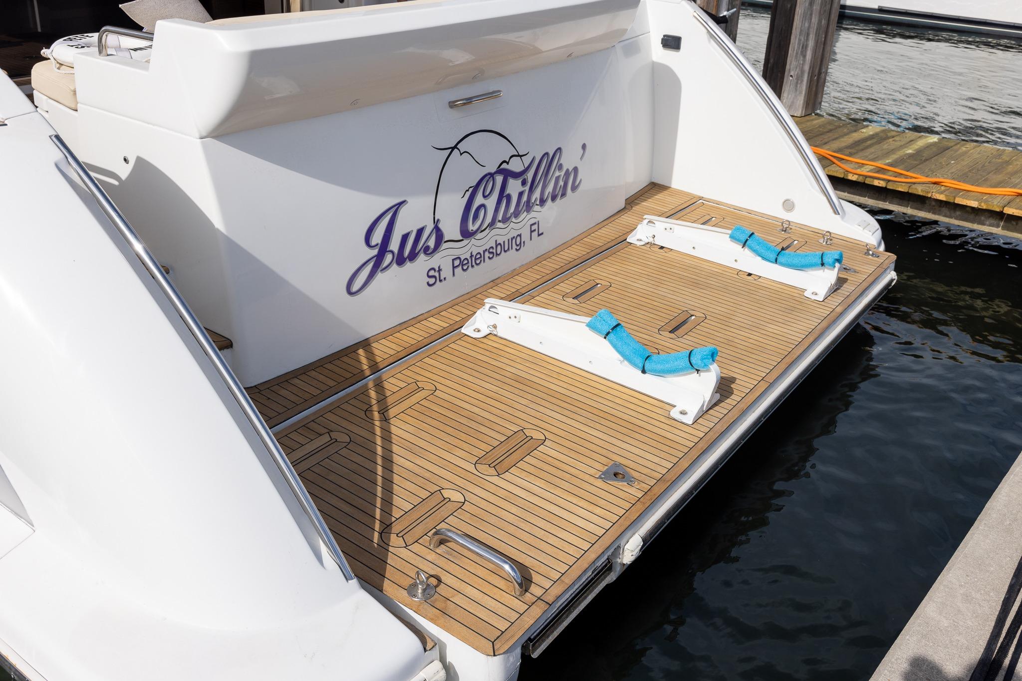 2014 Azimut 54 Flybridge yacht stern with wooden deck, docked in St. Petersburg, FL.