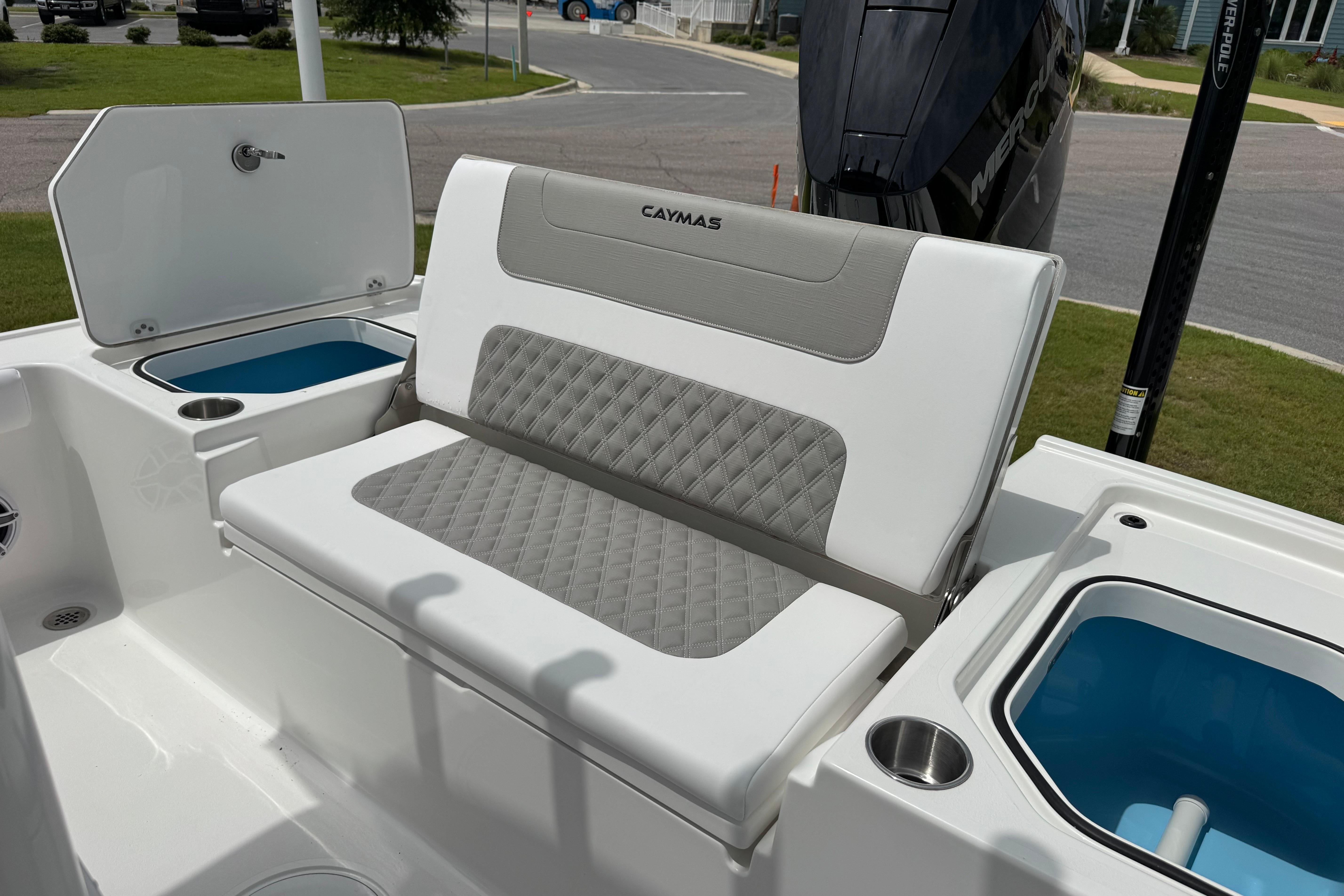 2027 Caymas 26 HB boat interior with cushioned seating and storage compartments.