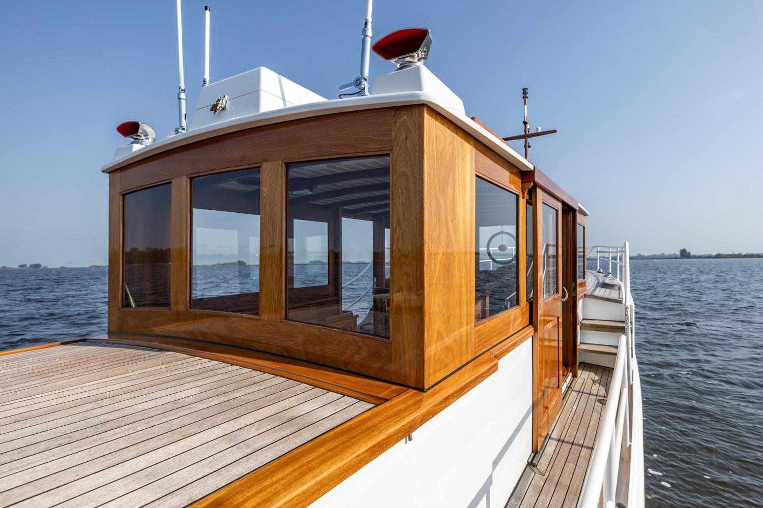 Classic 1932 De Vries Lentsch Bromo yacht with wooden cabin on open water.