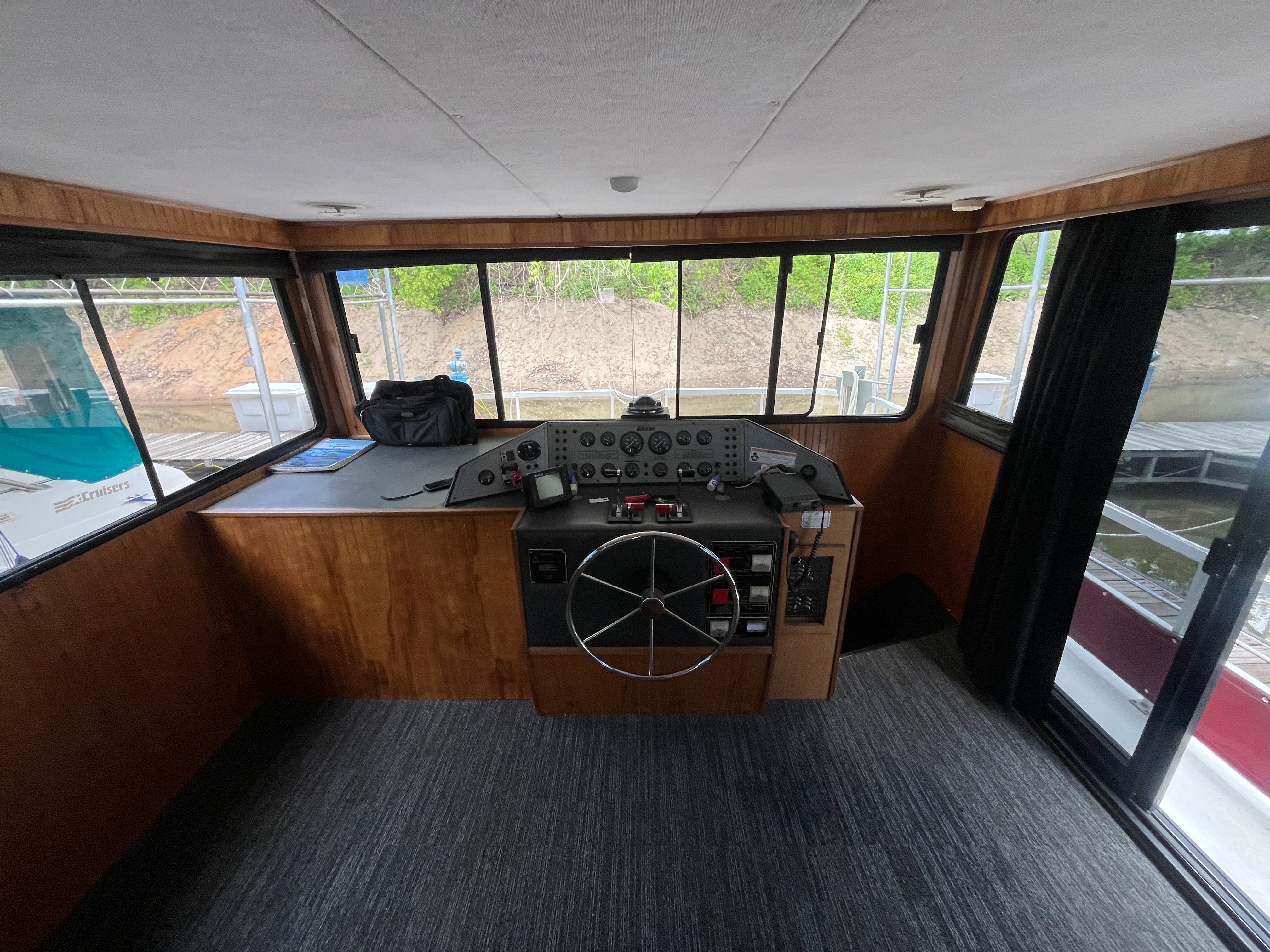 Interior of a 1995 Gibson Executive with helm station and large windows.