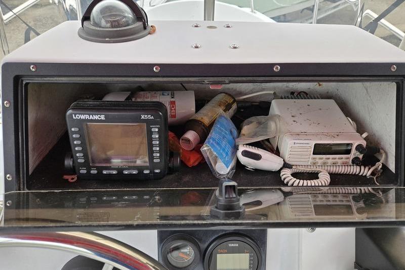 1996 Boston Whaler Outrage 17 console with electronics and storage compartment.