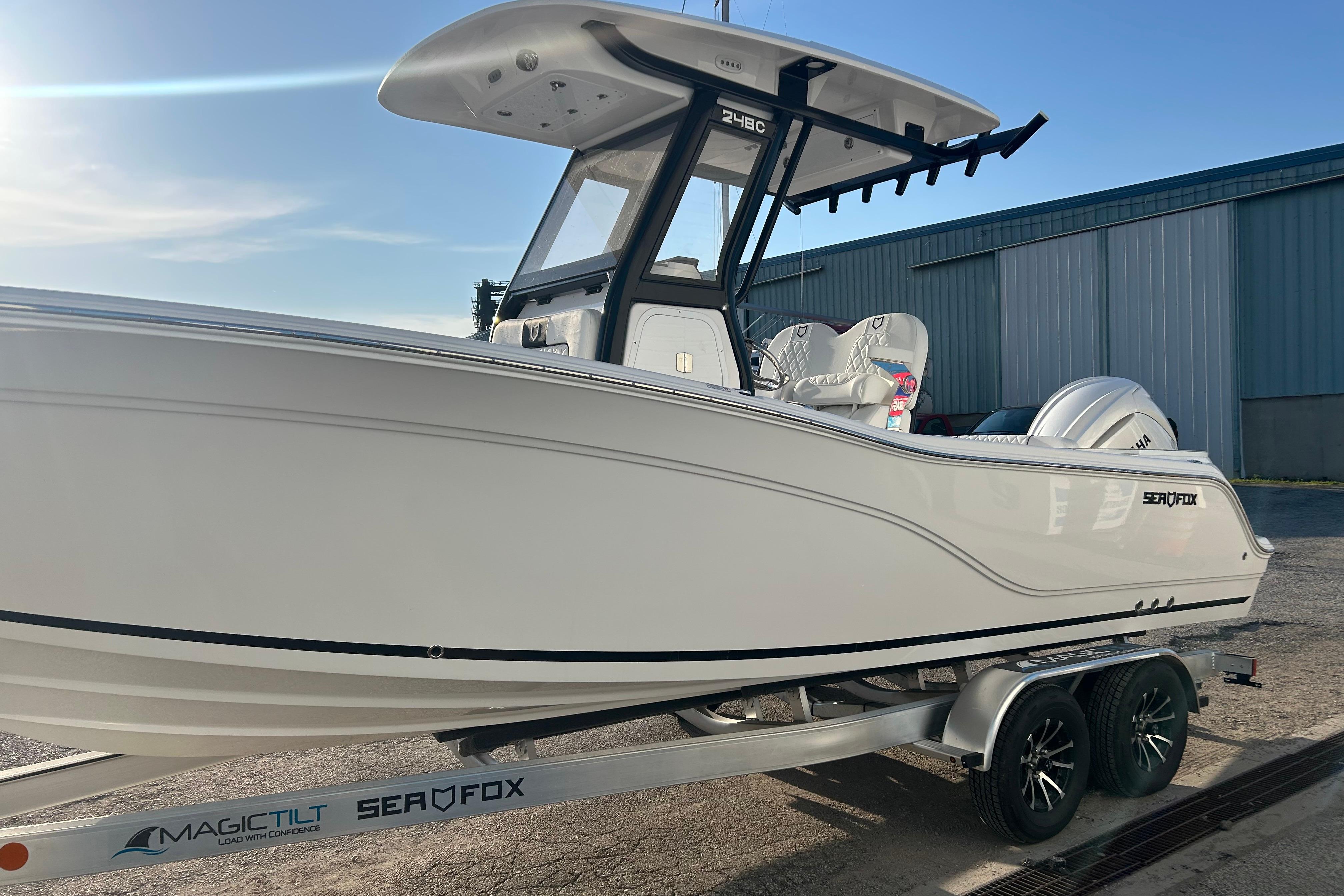 2026 Sea Fox 248 Commander boat on trailer, side view in sunlight.