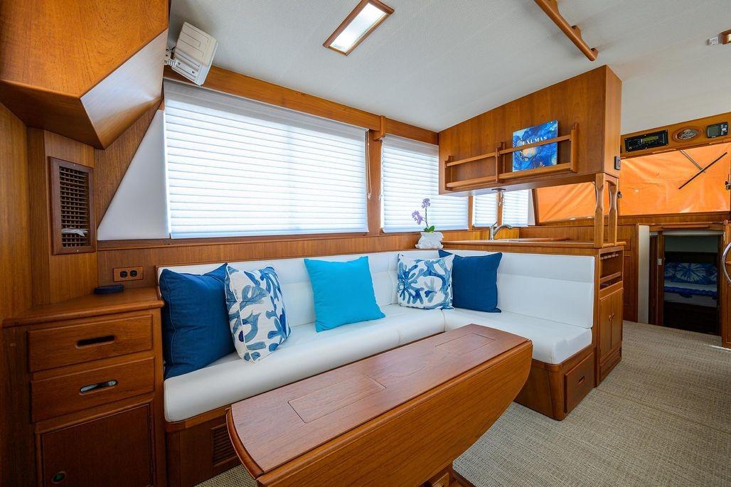 Interior of 1999 Grand Banks 42 Europa yacht with elegant wood finish and cozy seating.